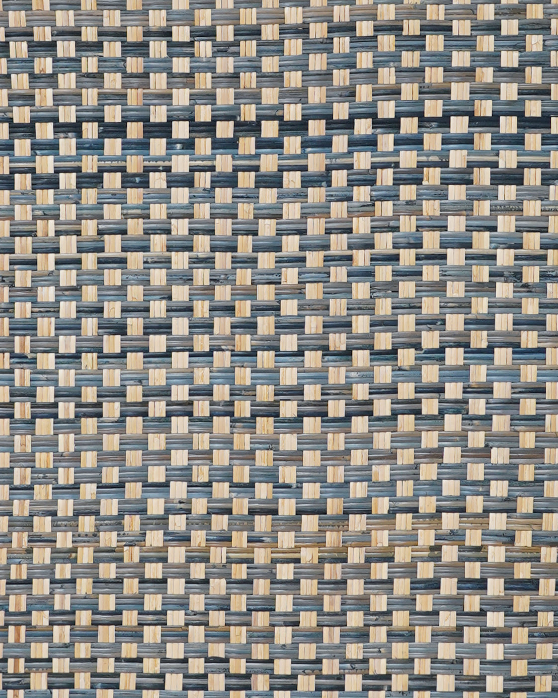 a close up shot of the texture of a blue check rattan headboard