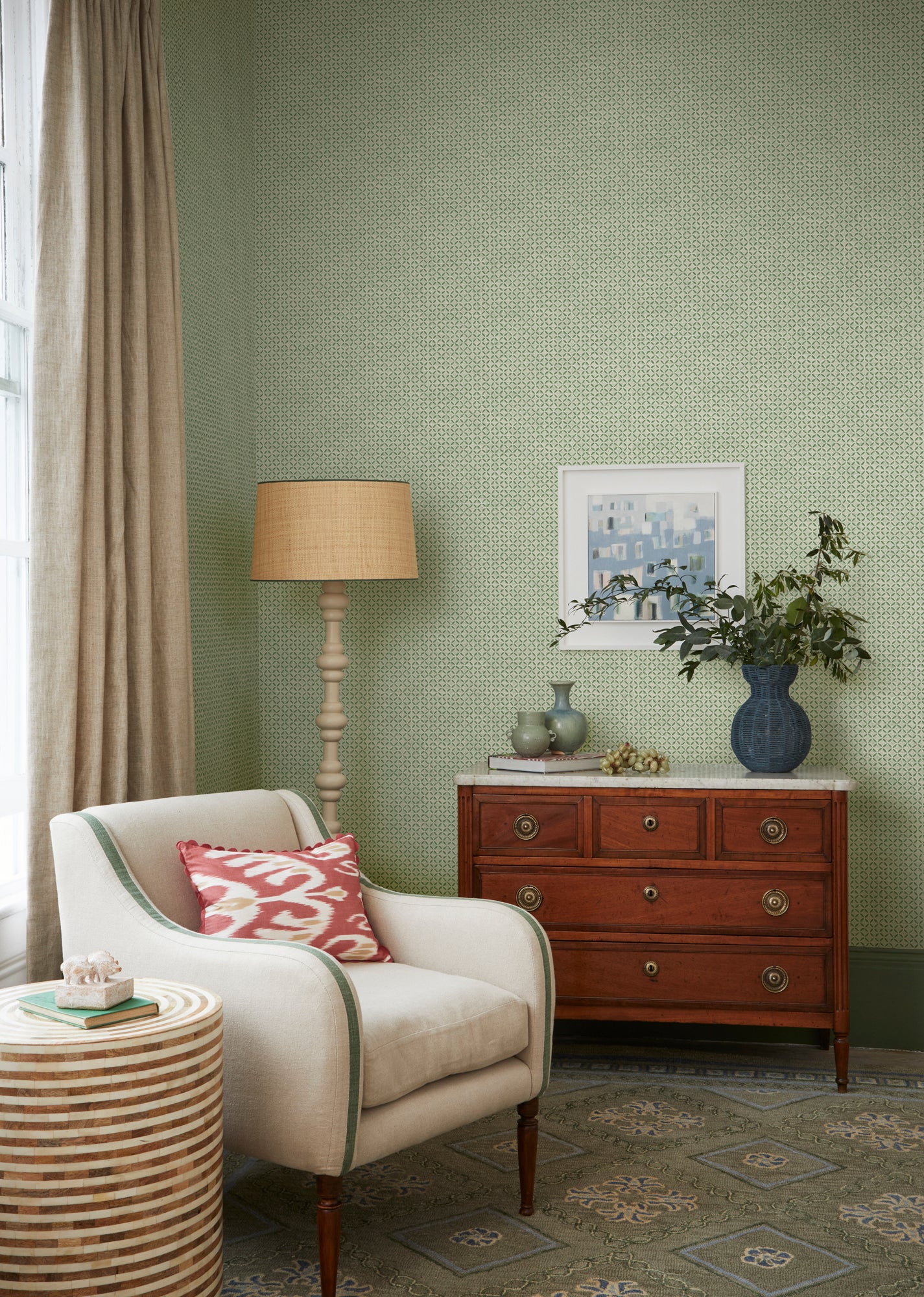 Green Sintra wallpaper lifestyle image, featuring the made to order green armchair, green Varuna rug and Havana side table