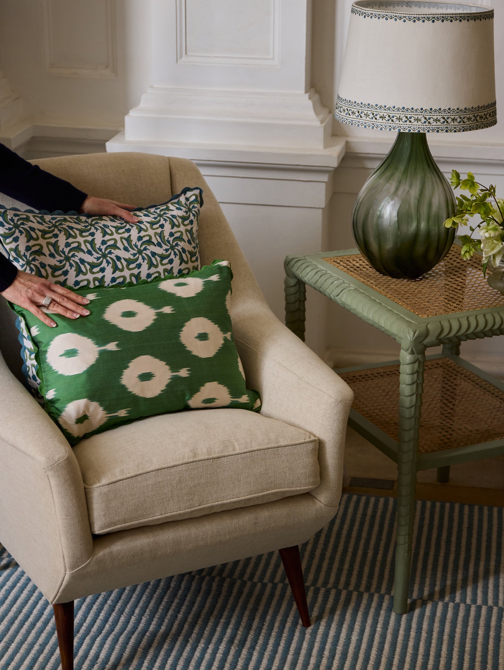 Hands on cushions on armchair