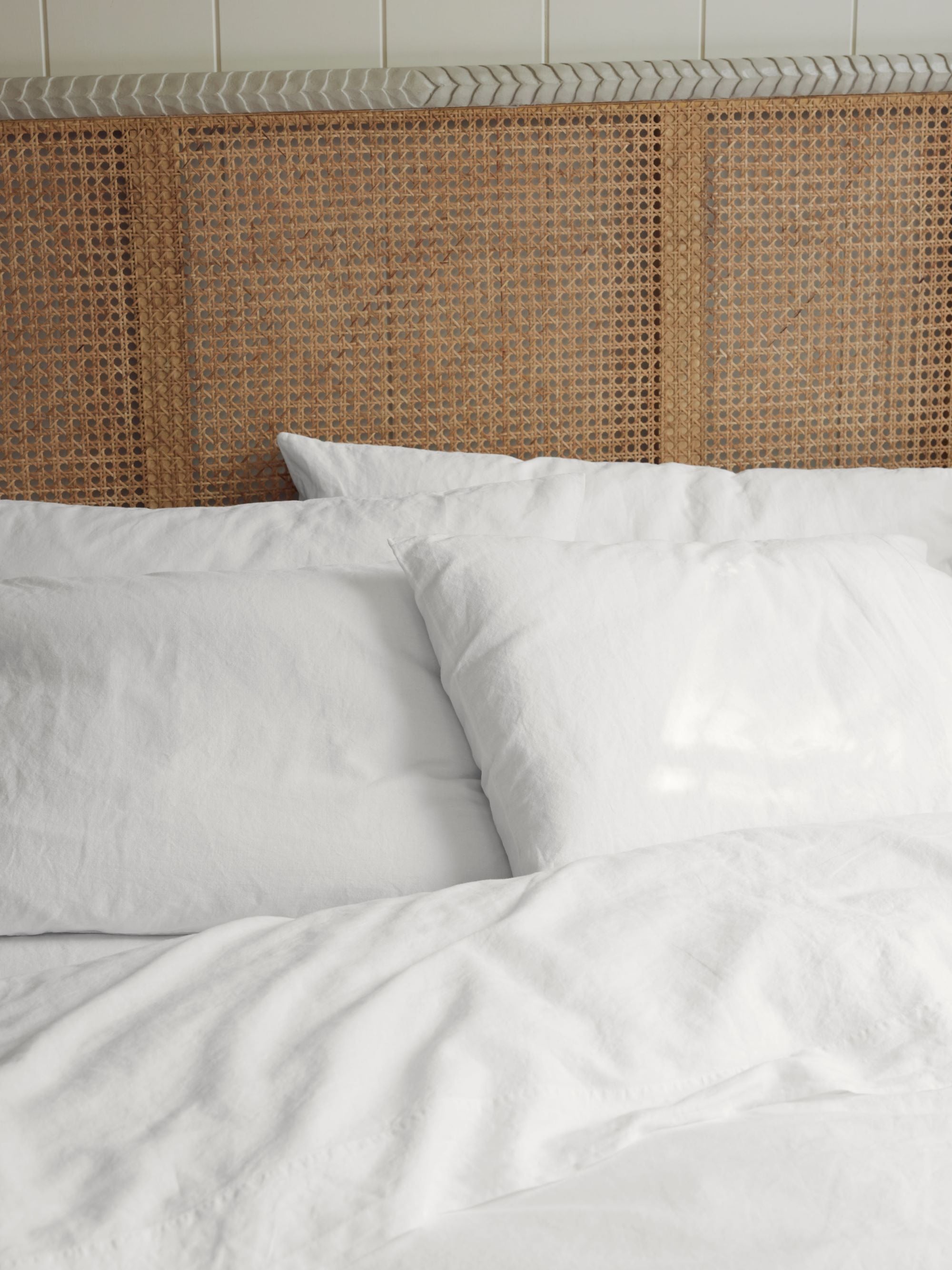 crisp white sheets by Piglet in bed styled with a pavilion headboard by Birdie Fortescue