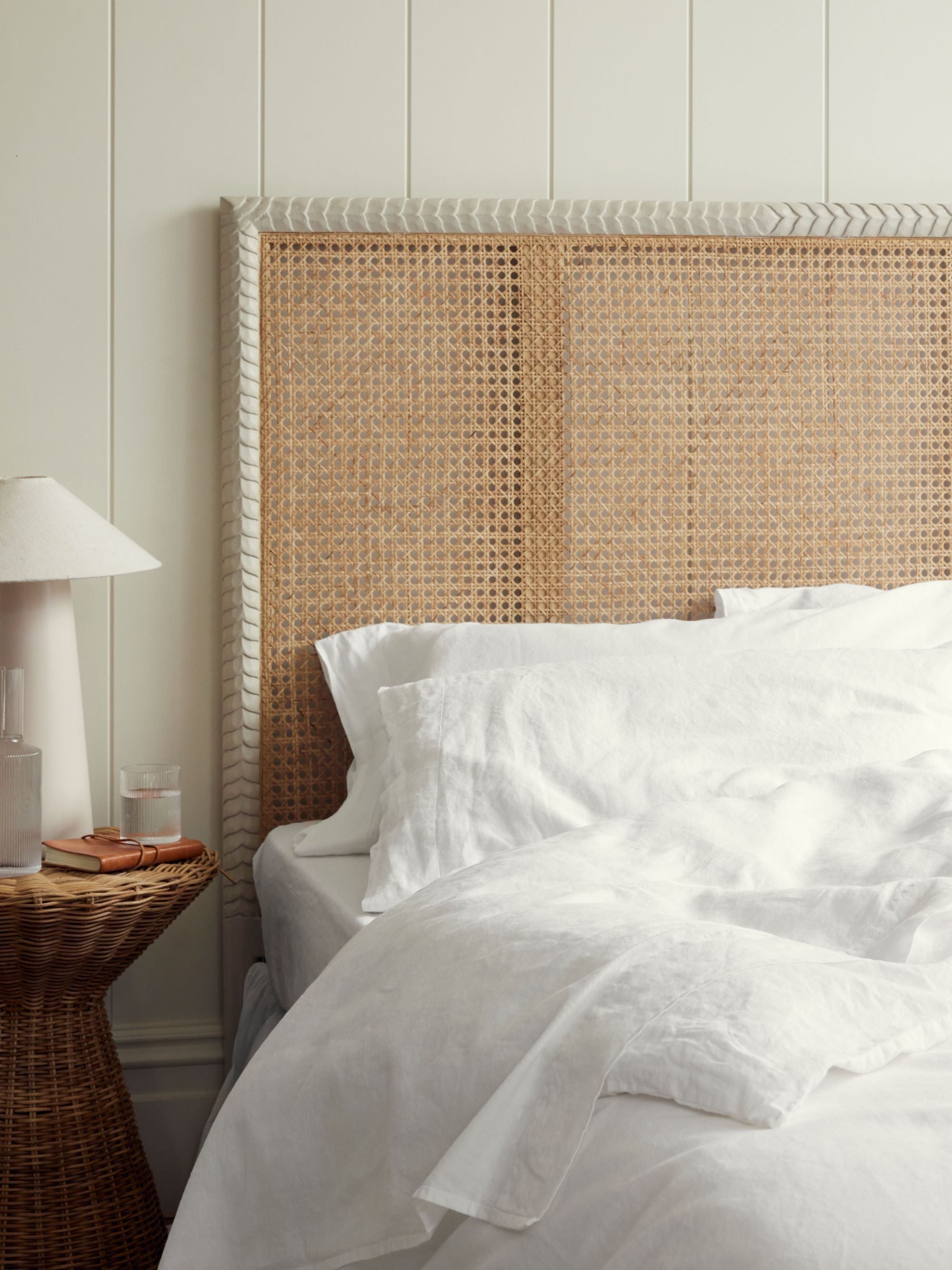 crisp white sheets by Piglet in bed styled with a pavilion headboard by Birdie Fortescue with a white lamp