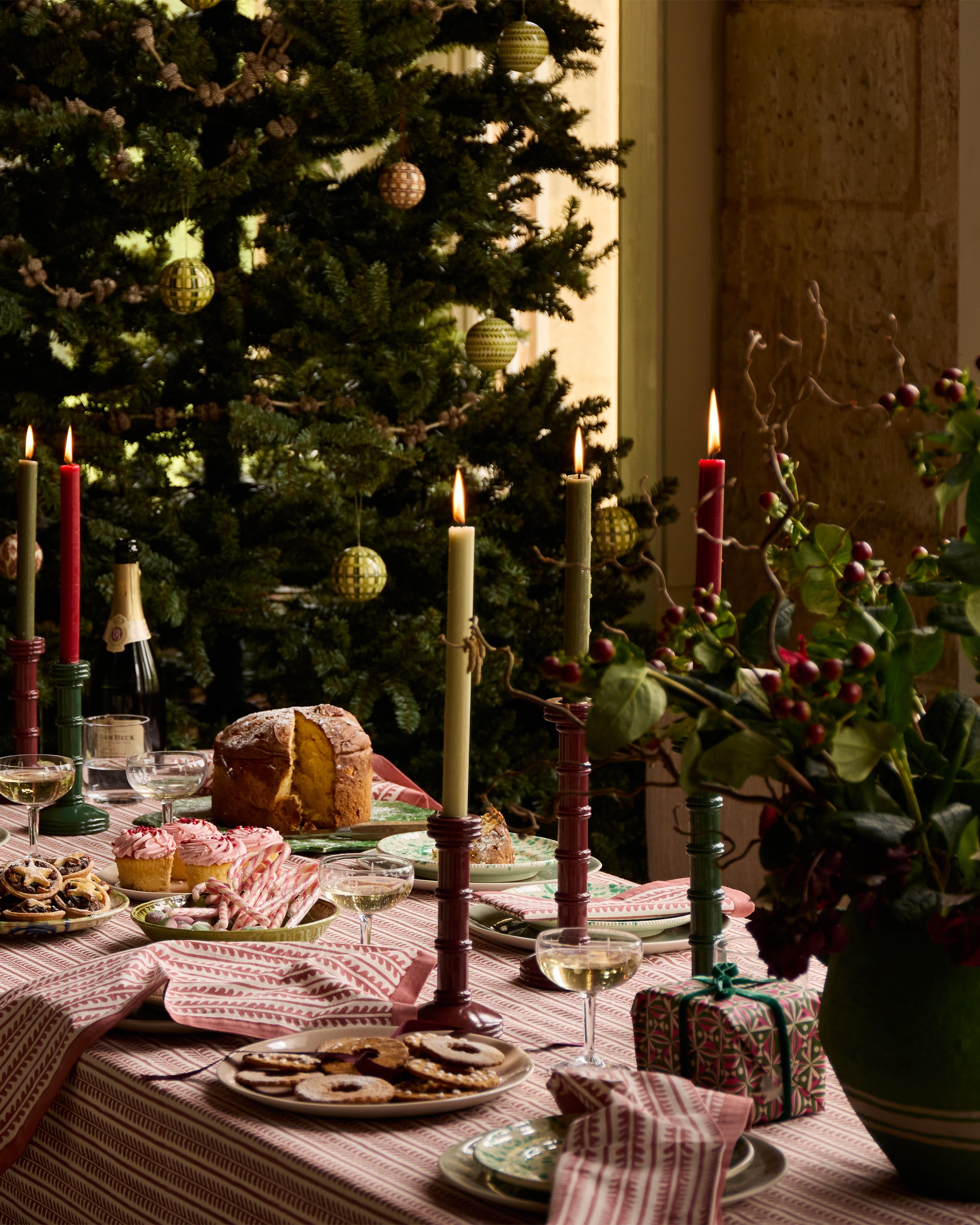 Festive dining table, with red bel table linens and red and green column candlesticks