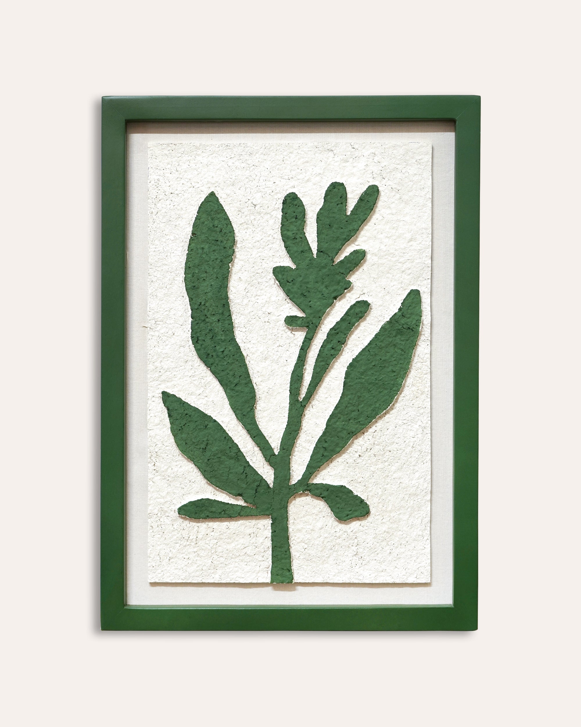 Framed artwork of green leaves on a white background