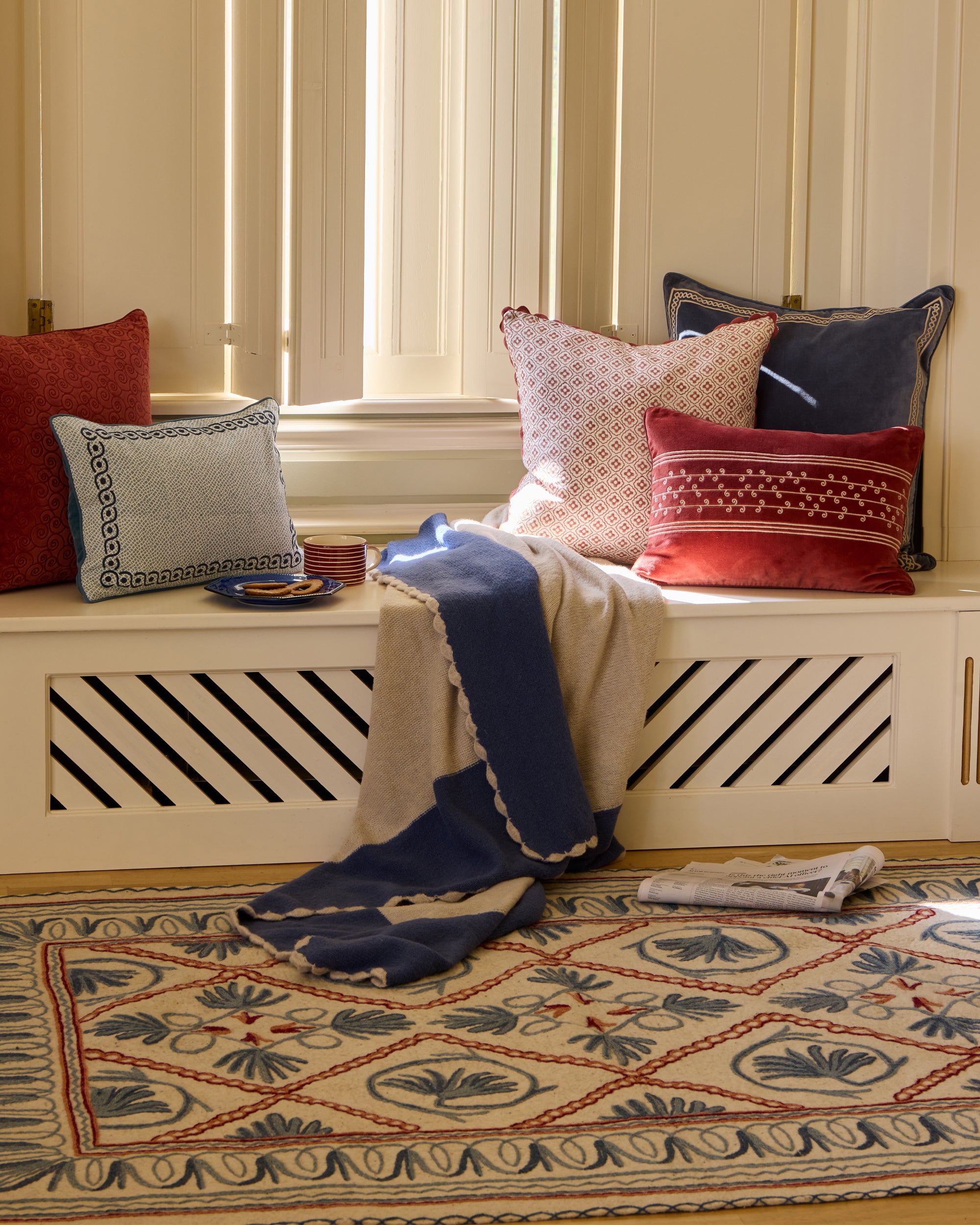 Red and blue cushions on a window seat