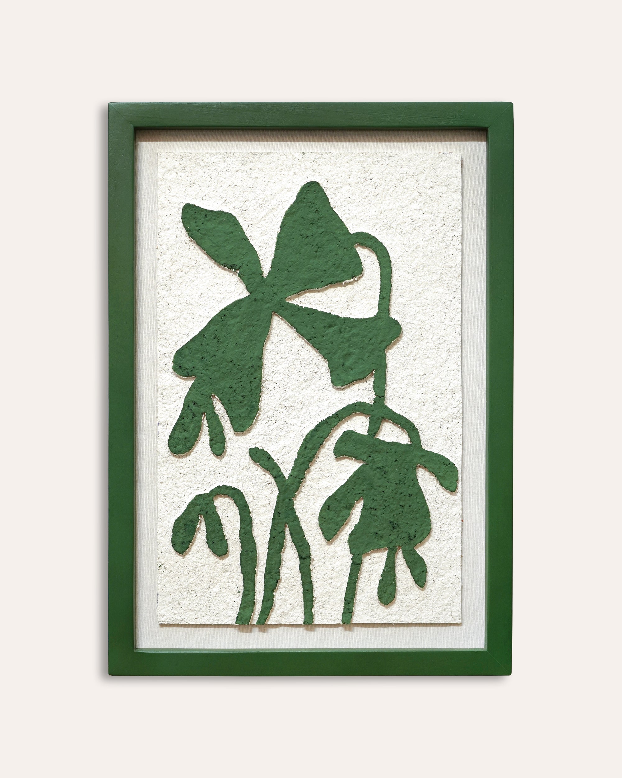 Framed artwork with green leaf patterns on a white background