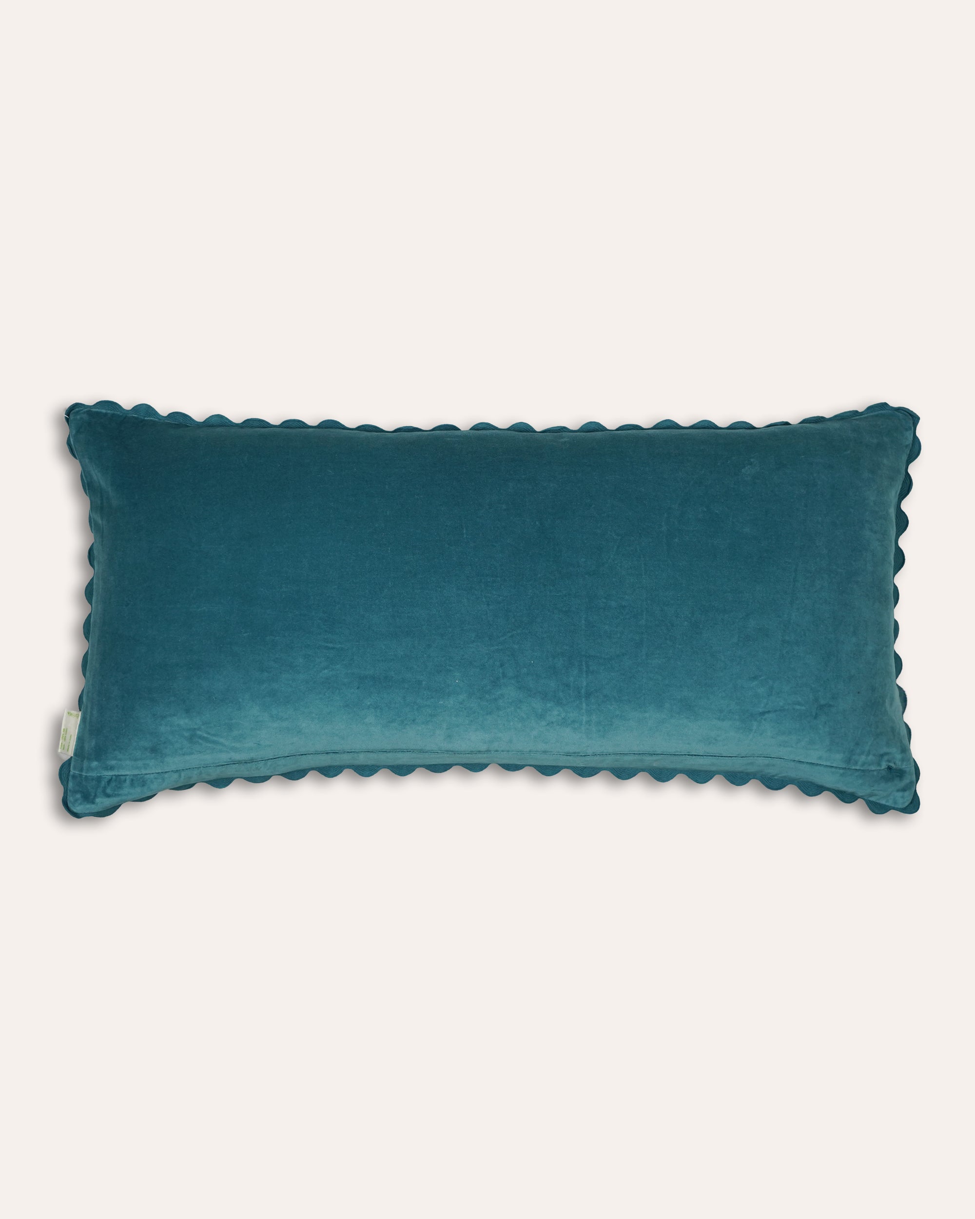 Blue velvet rectangular cushion with a scalloped ricrac edging