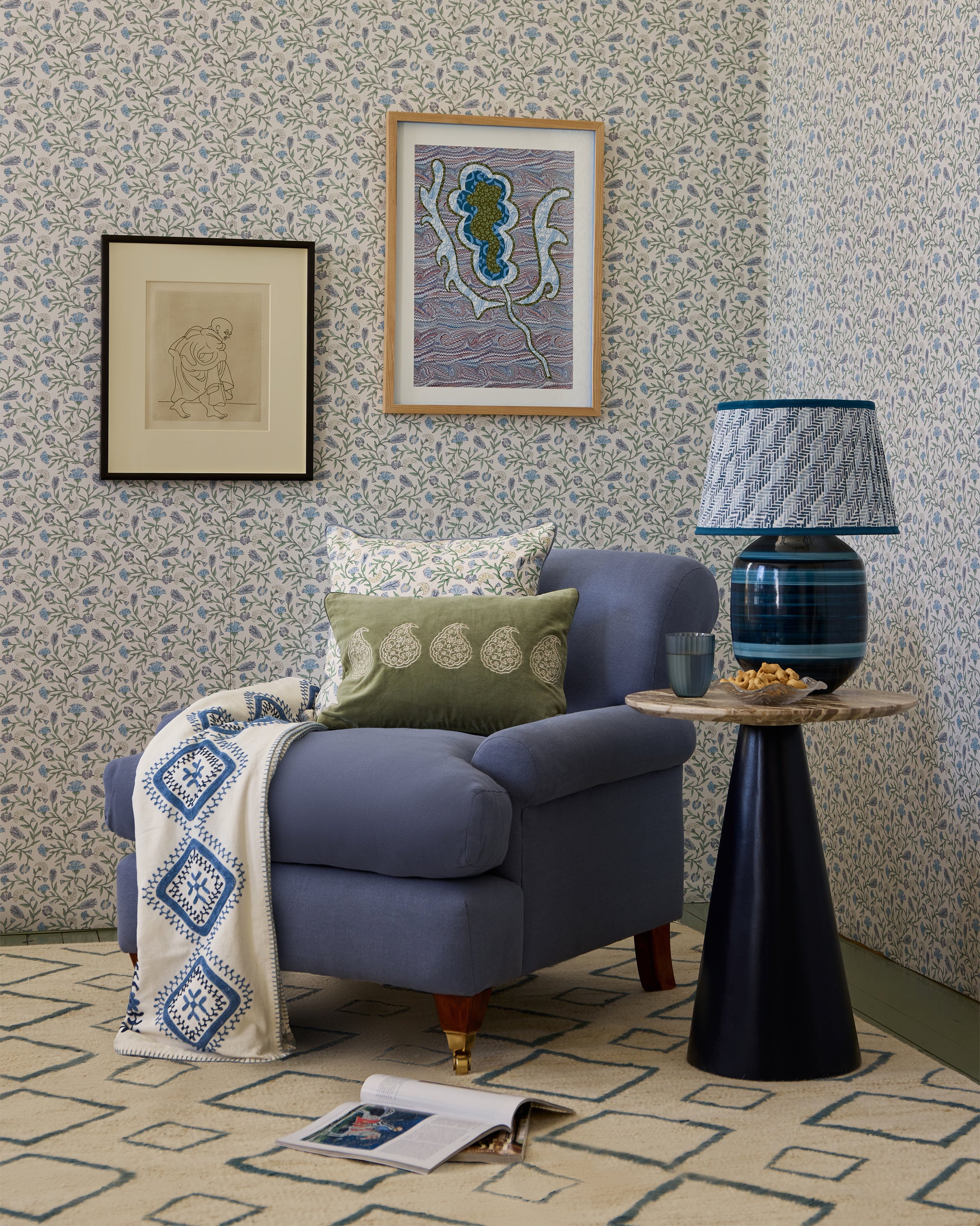 Living room with a blue armchair, side table, and decorative elements.