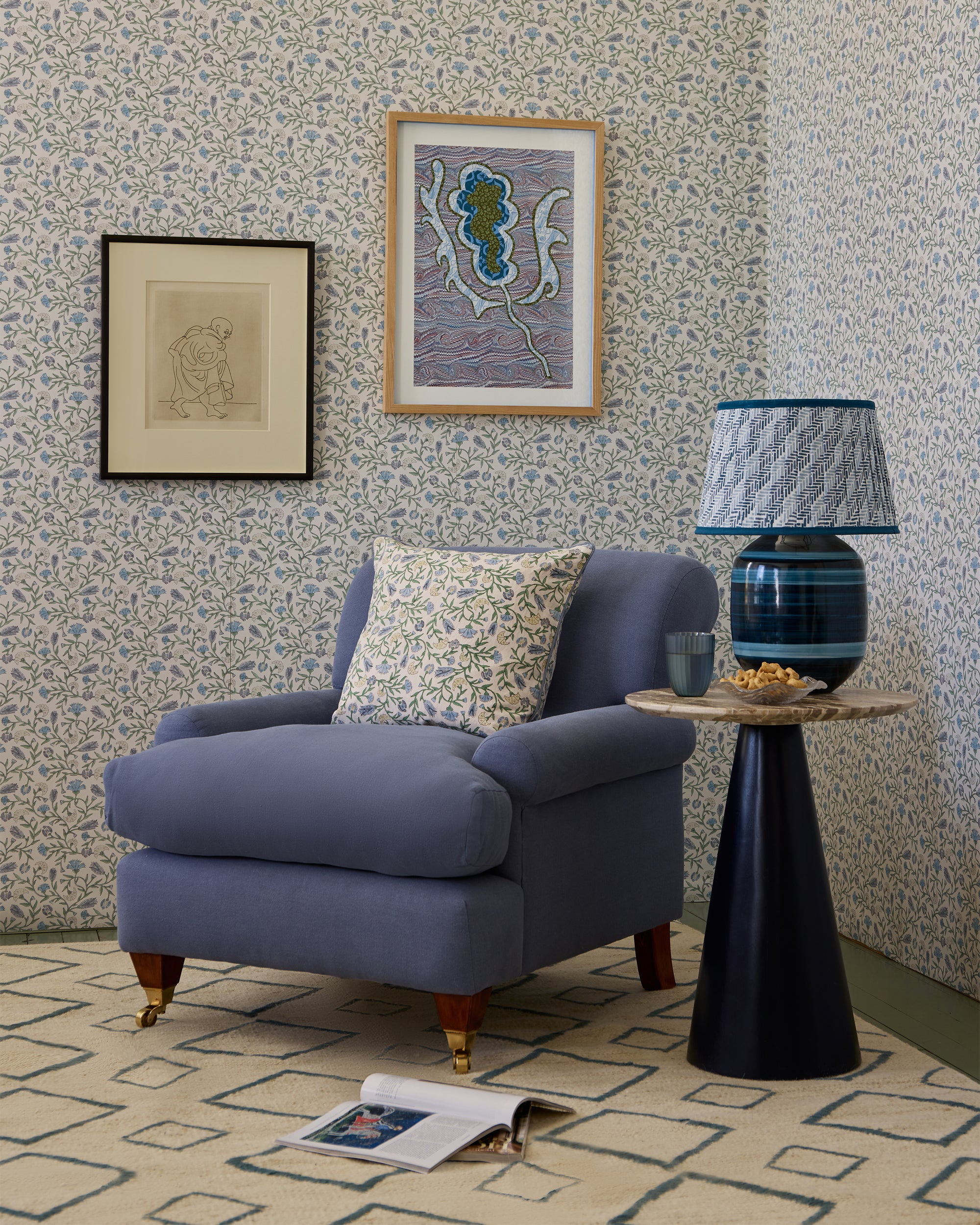 Cozy living room with a blue armchair, side table, and decorative elements.