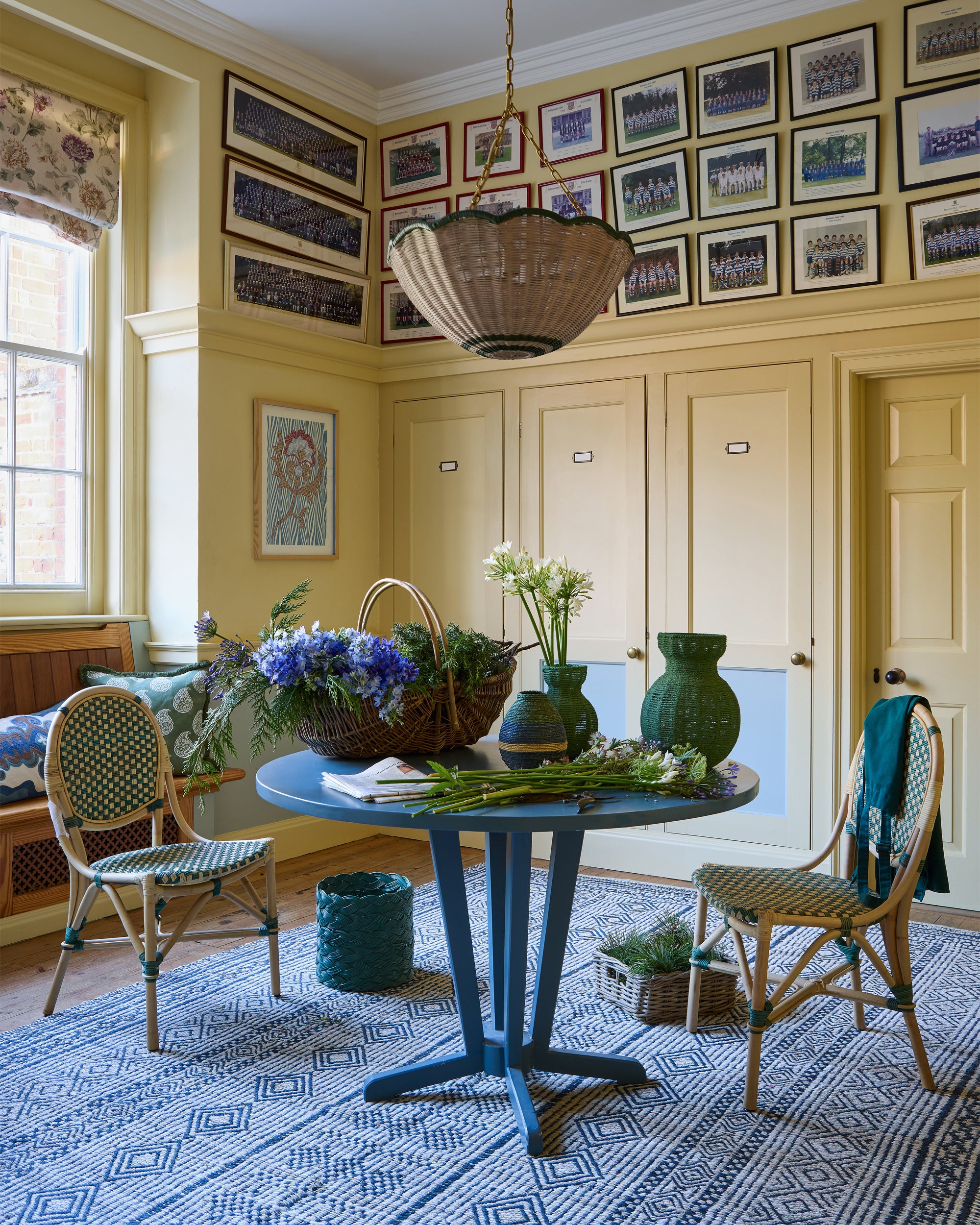 Boot room with a blue table, chairs, and decorative elements.
