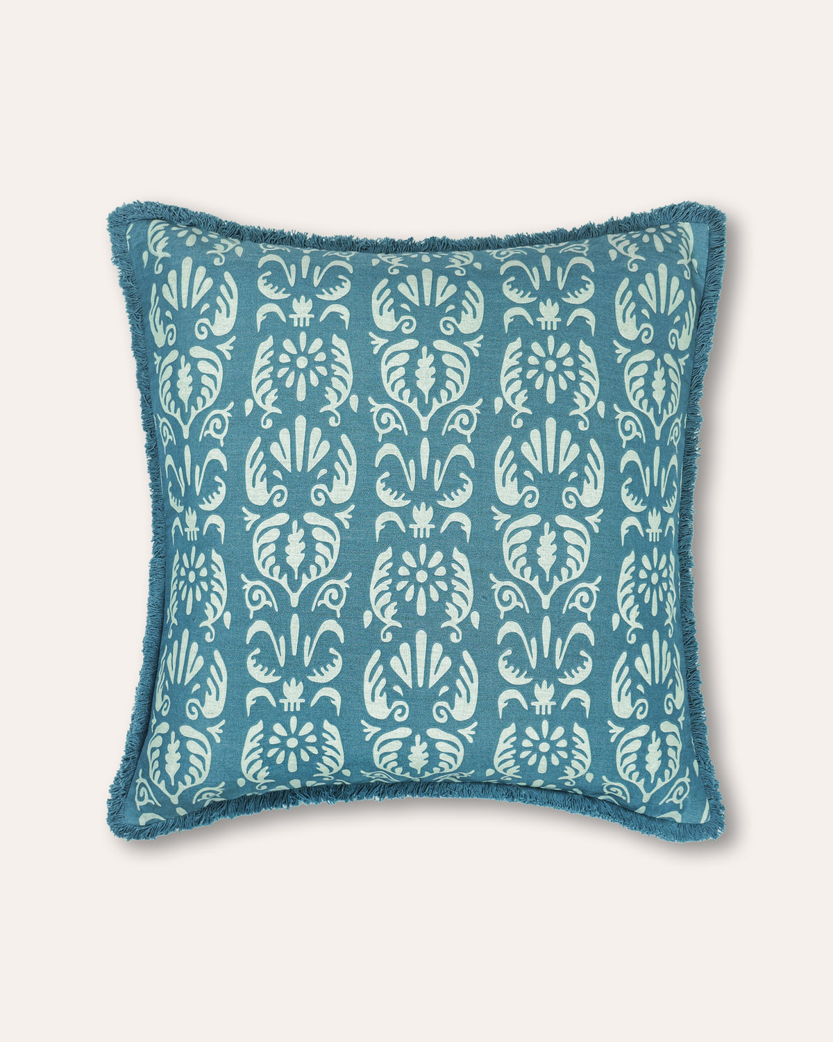 A square throw pillow featuring a teal blue and white damask pattern with a fringed edge, set against a solid off-white background.