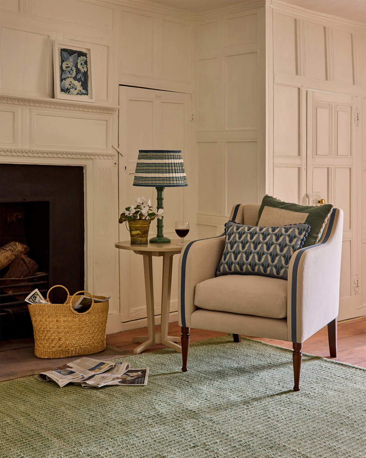Living room with a beige armchair, side table, and decorative items.
