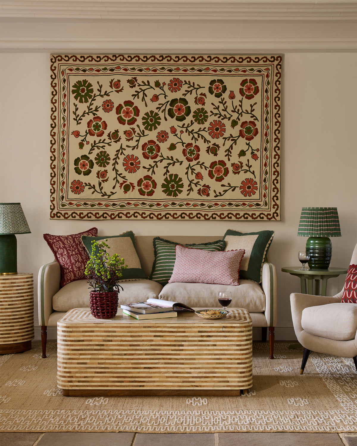Sitting room with floral tapestry, sofa, and coffee table.