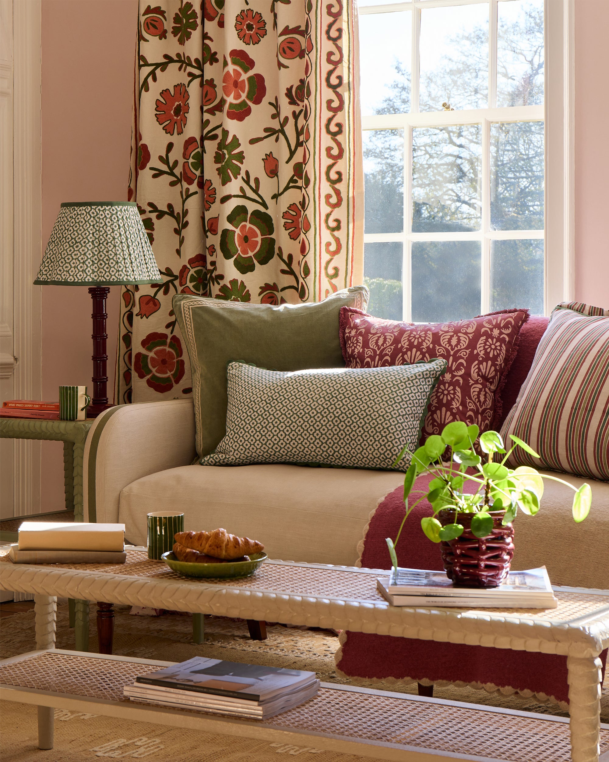 Sitting room with a beige sofa, decorative pillows, and a coffee table.