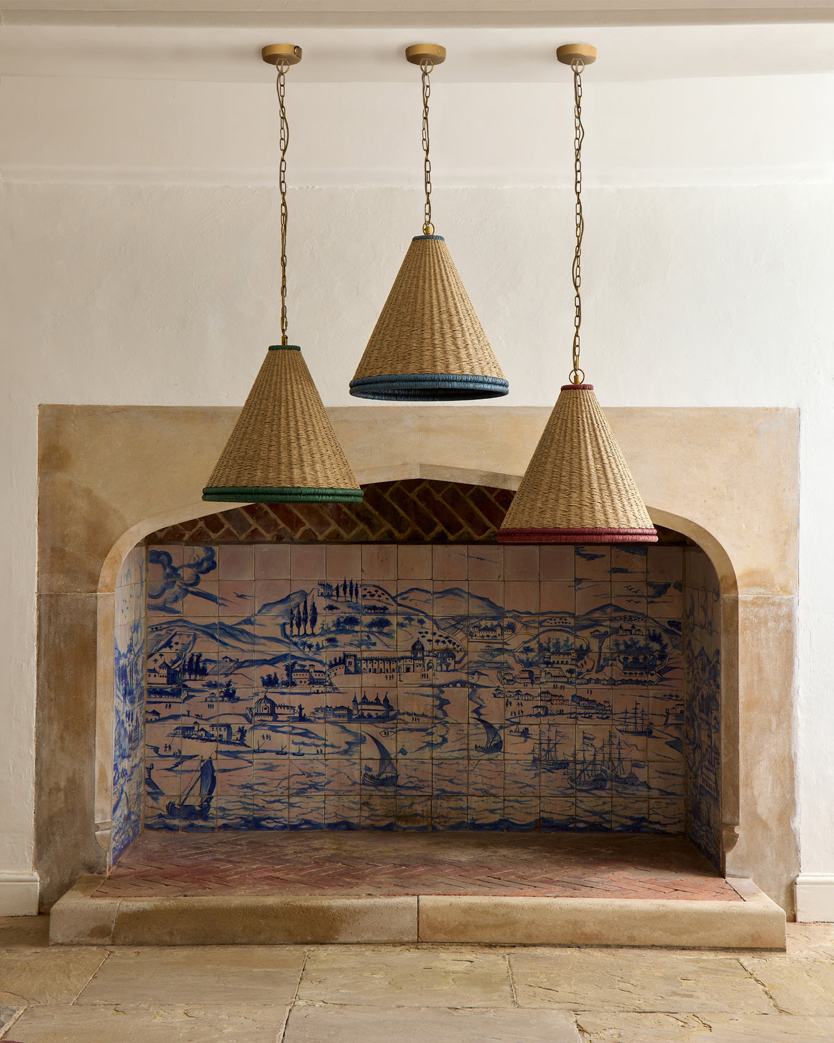 Decorative fireplace with tiled back and hanging wicker lamps.