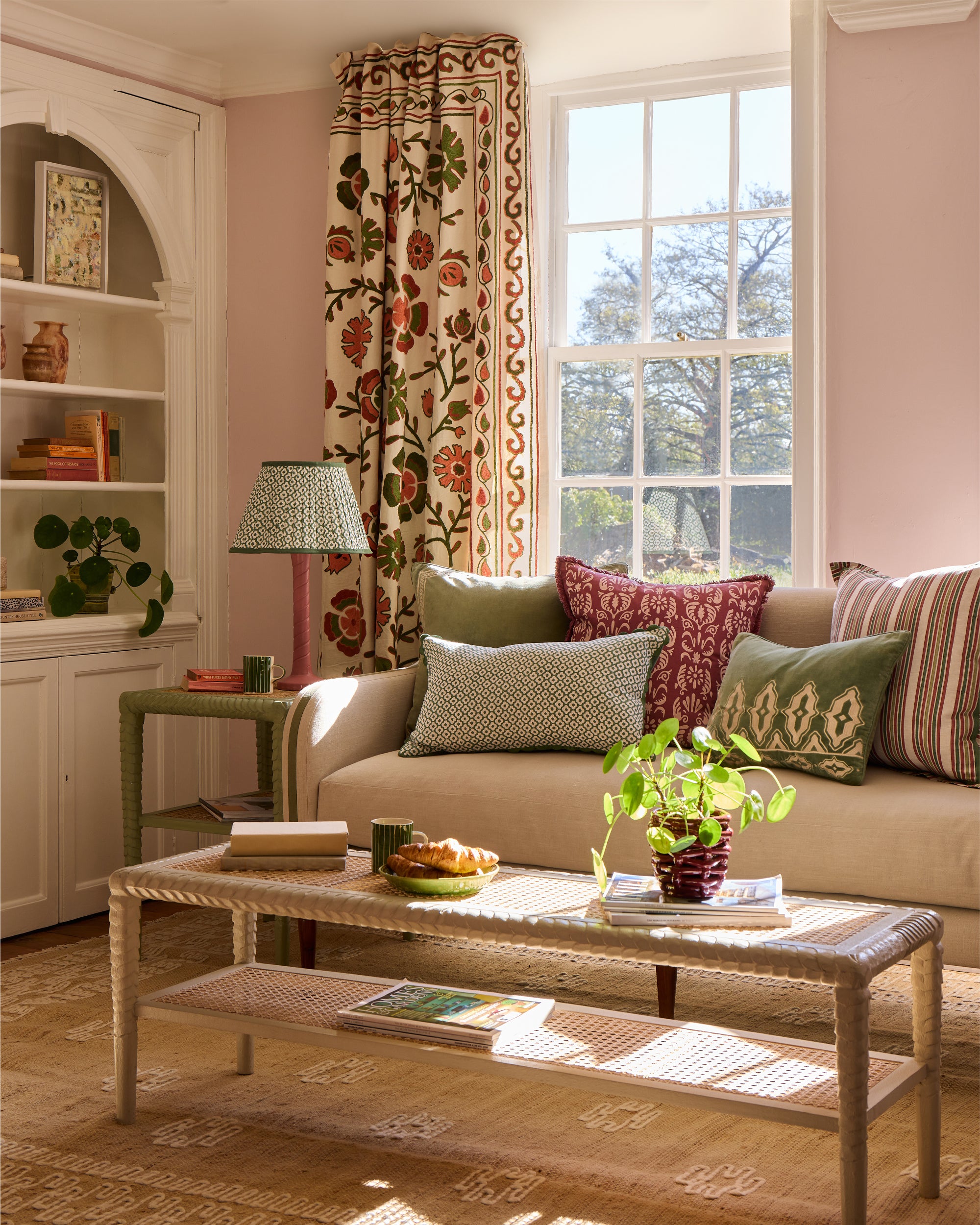 Living room with beige sofa, decorative pillows, and a coffee table.