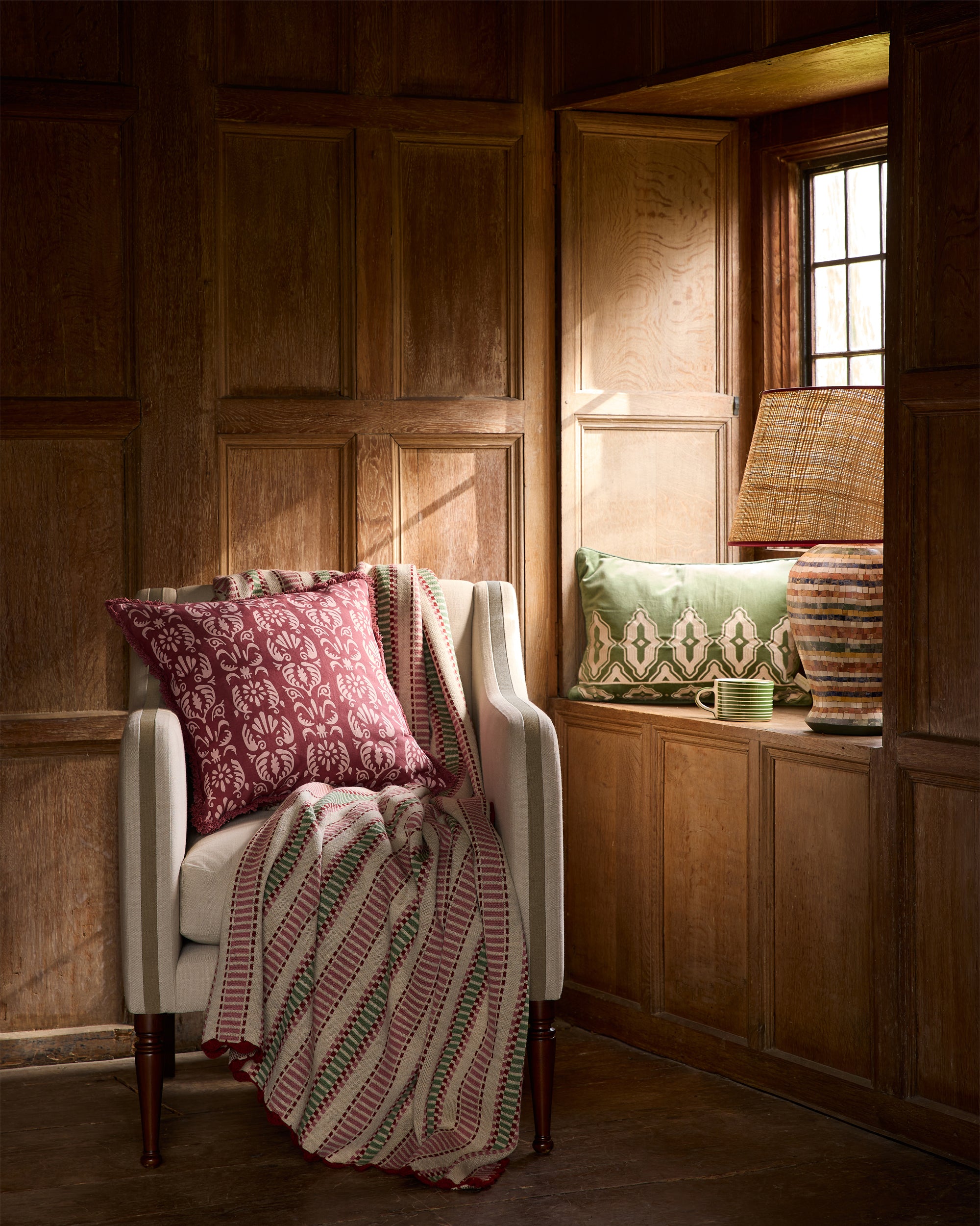 Chair with patterned blanket and cushion in a wooden room