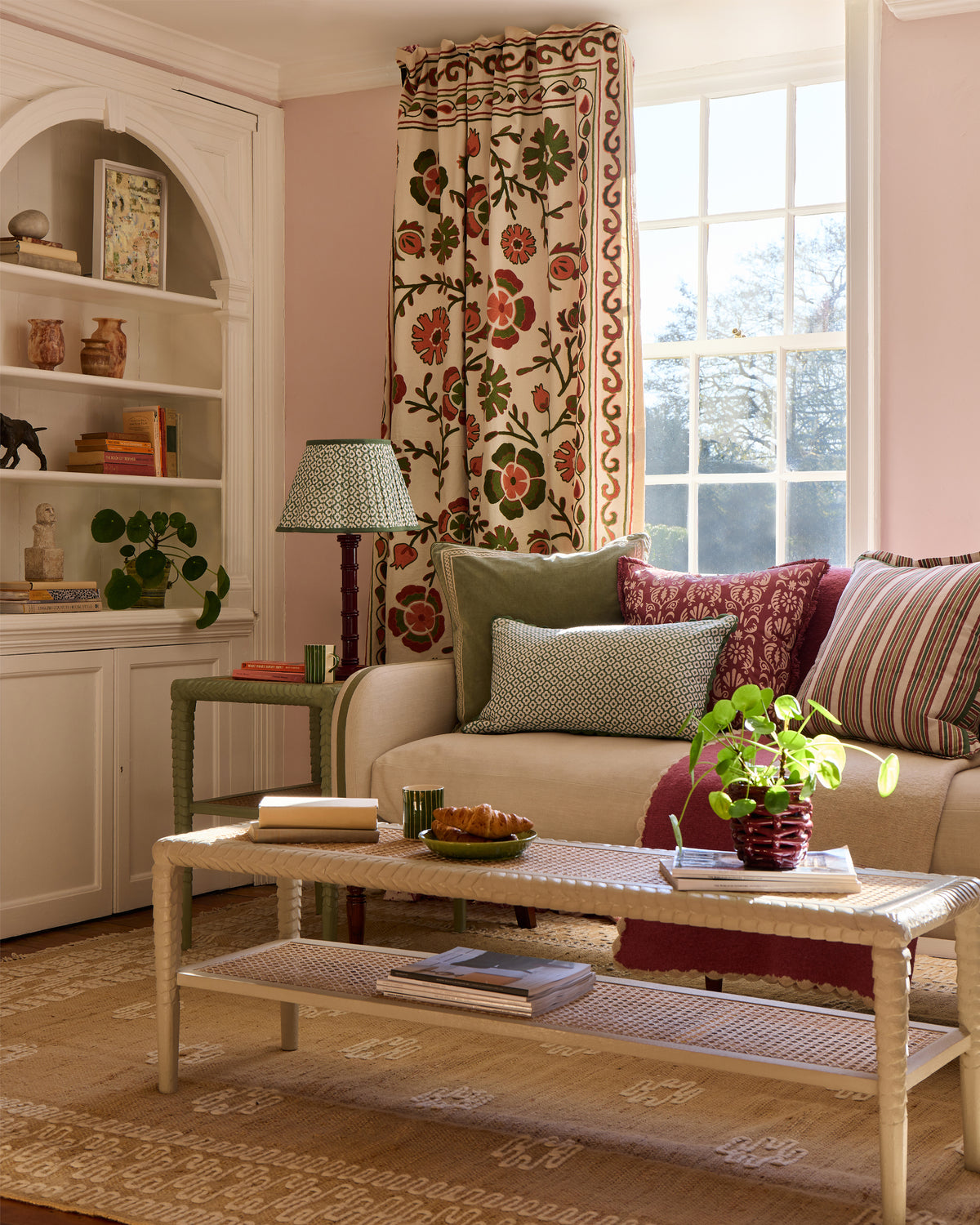 Sitting room with a beige sofa, coffee table, and decorative elements.