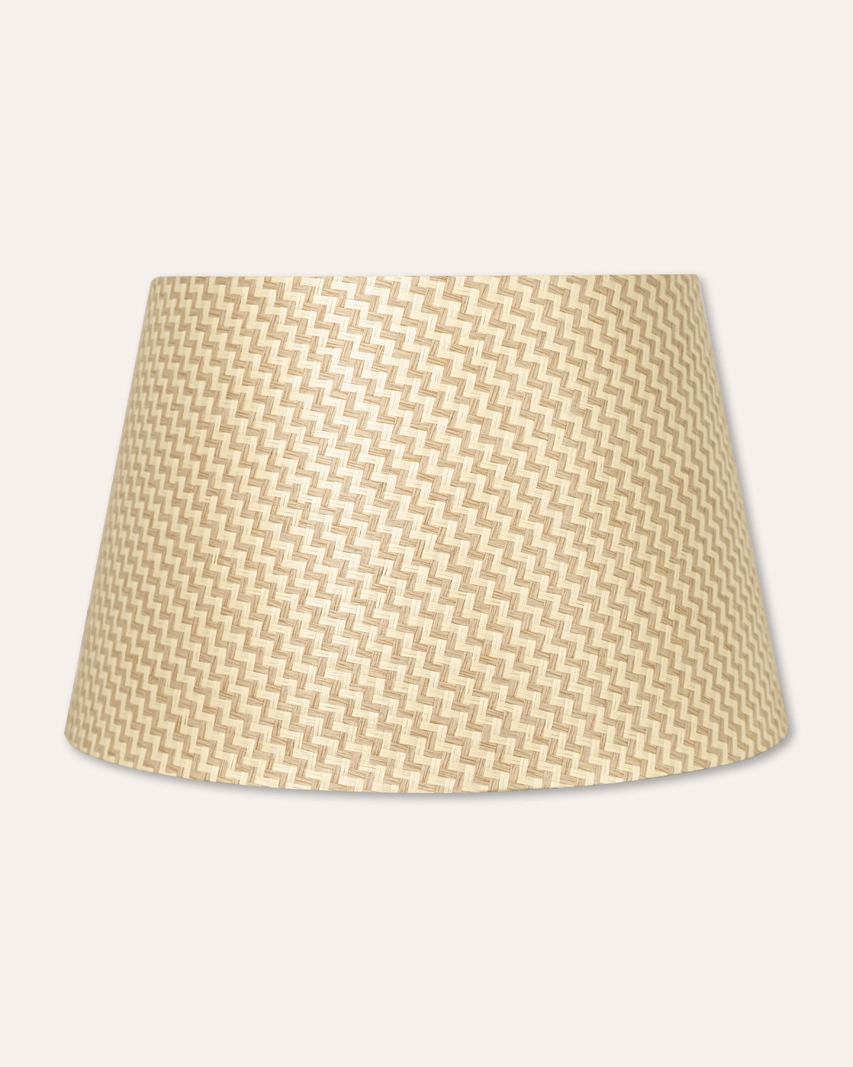 A tapered lampshade with a beige and cream chevron pattern, shown against a solid off-white background.