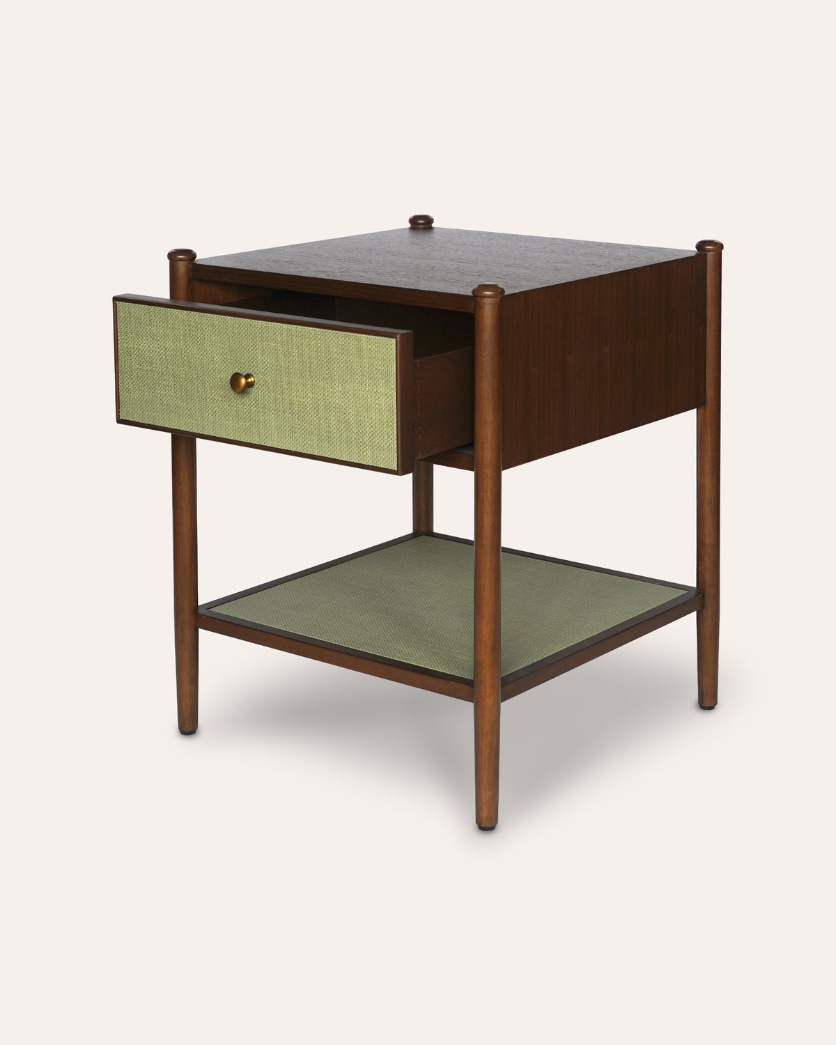 Mid-century modern side table with a dark wood frame, a light green woven drawer front, a matching green shelf, and a small brass knob.