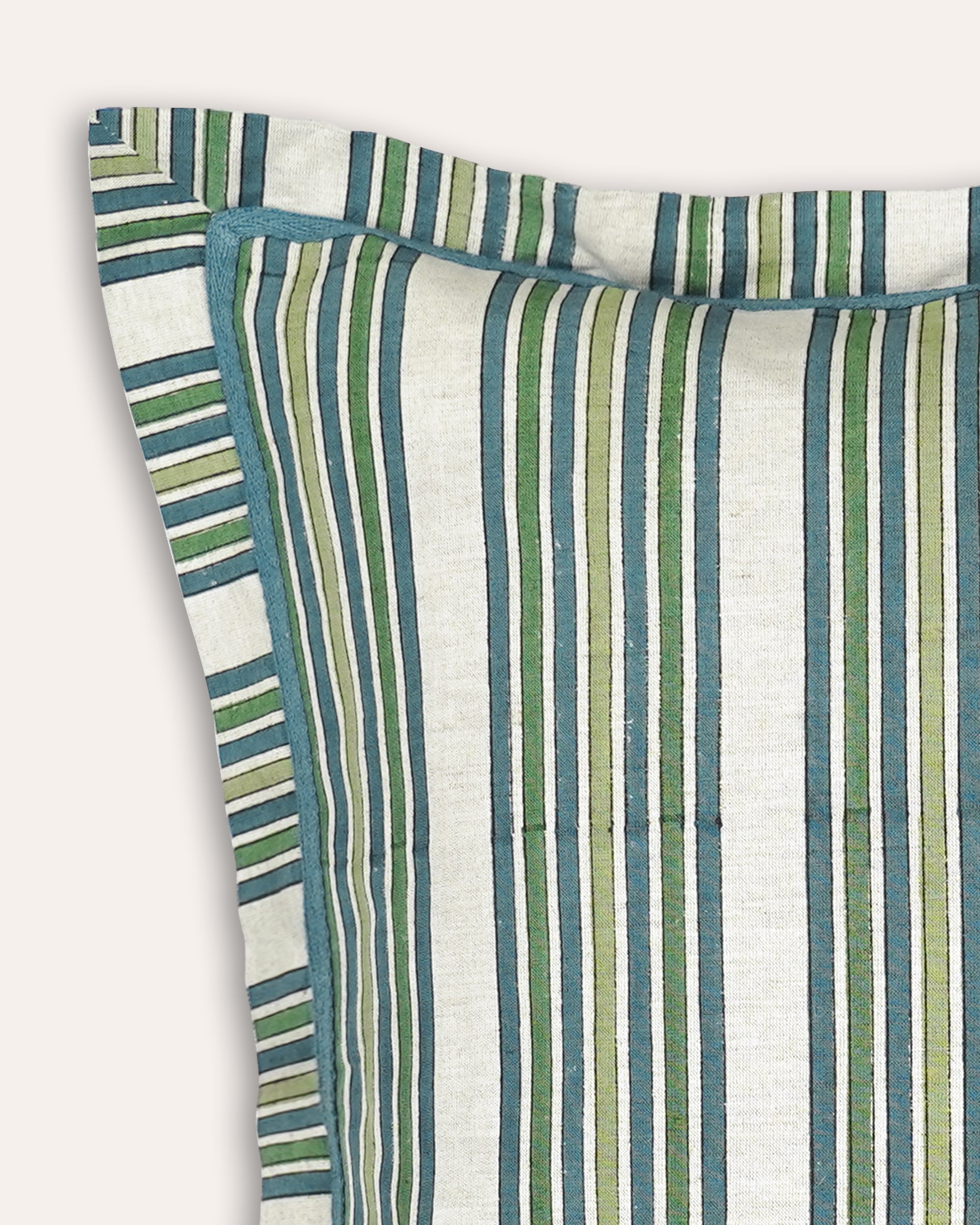 A close-up of a striped cushion, featuring vertical stripes in teal blue, sage green, olive, and cream on a light fabric background.