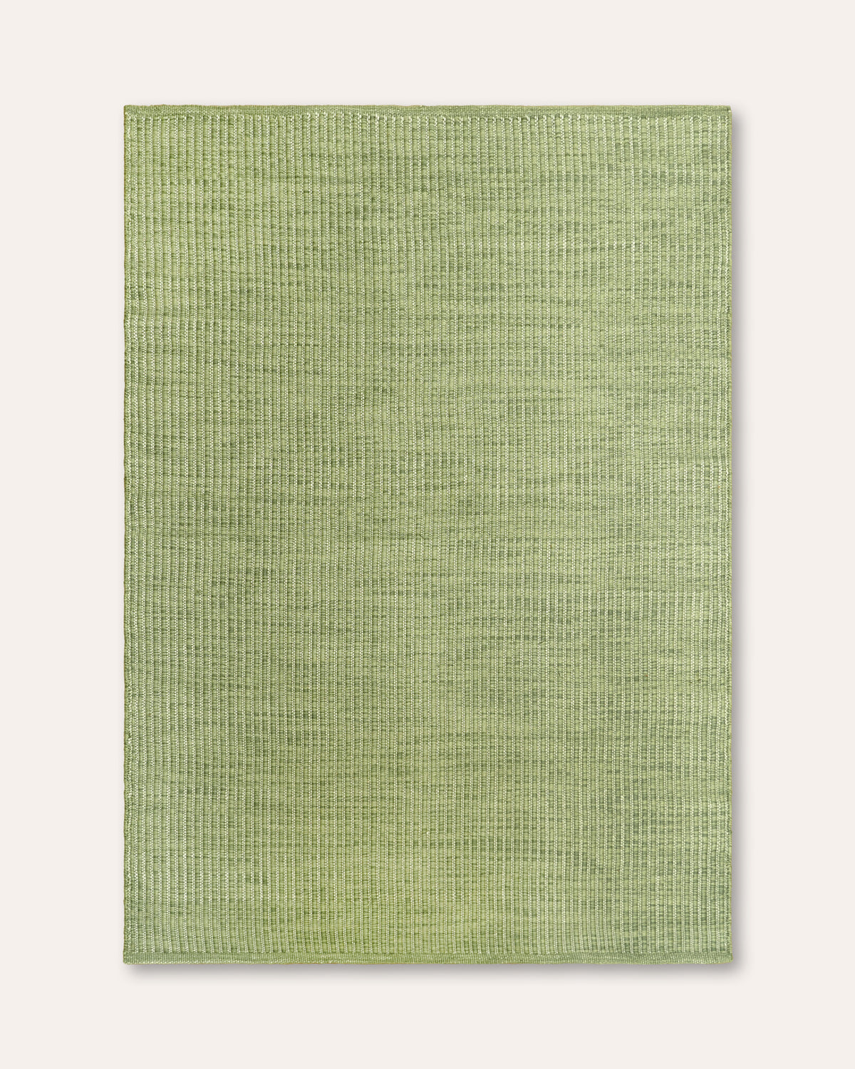 A rectangular sage green textured rug with a woven basketweave pattern, shown flat against a light beige background.