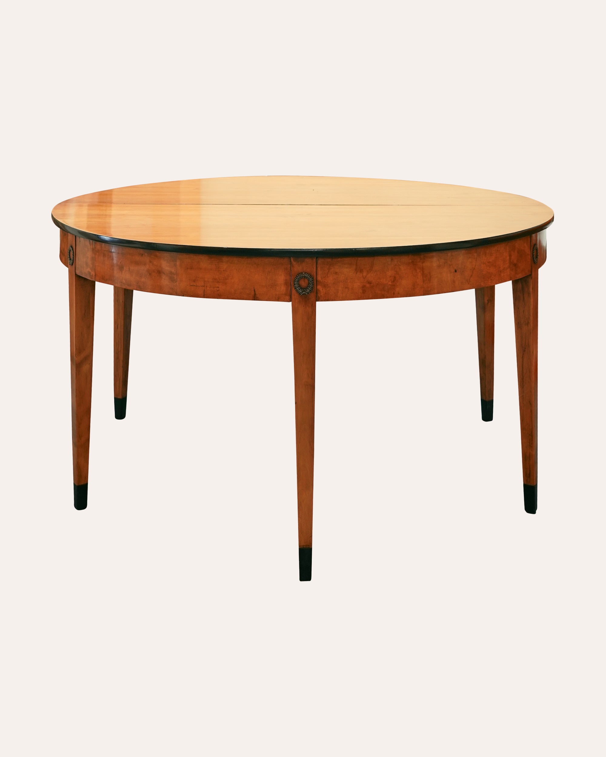 A smart 19th Century circular dining table separating into a pair of generous Demi-Lune Console Tables