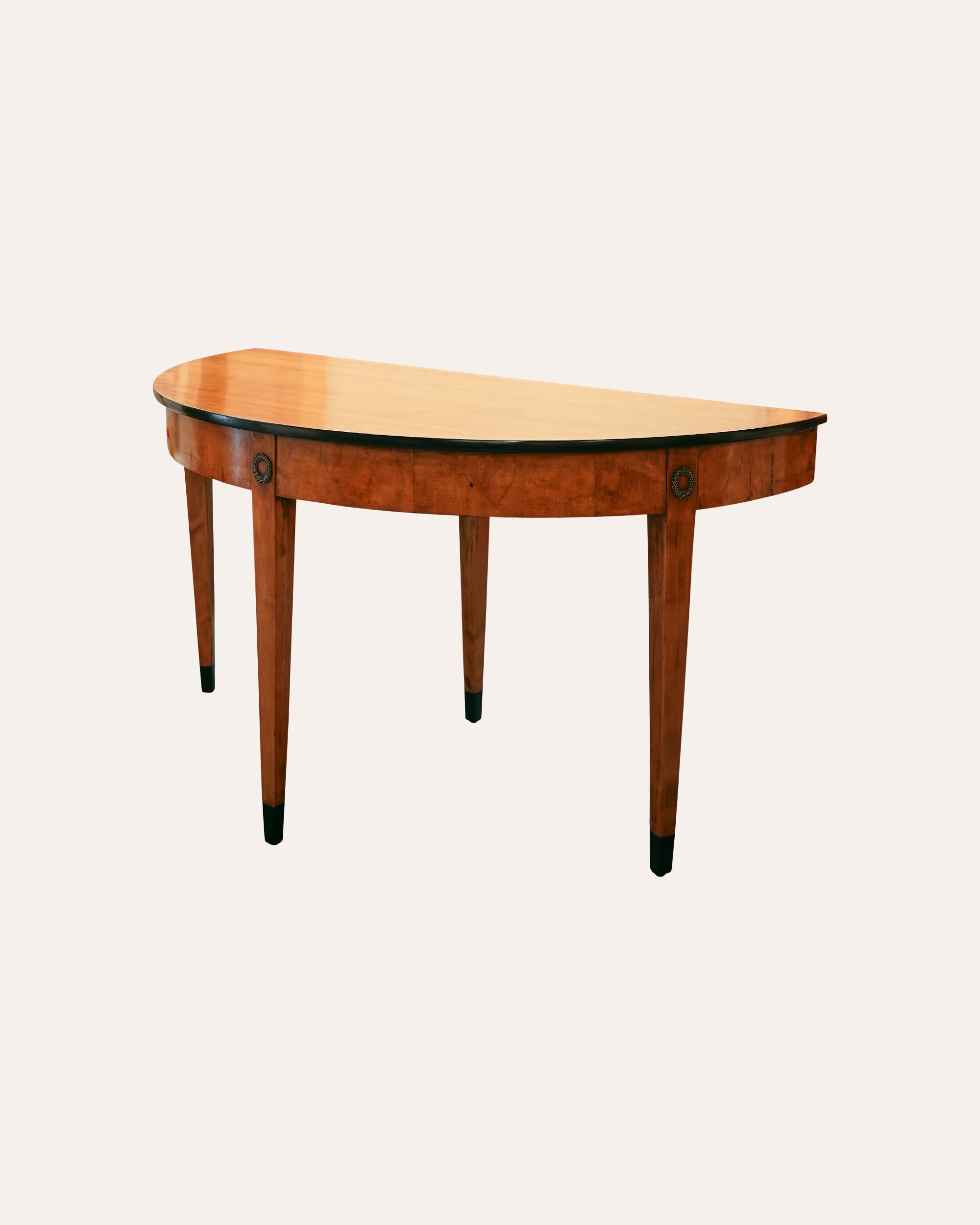 Wooden console table with a curved top on a white background