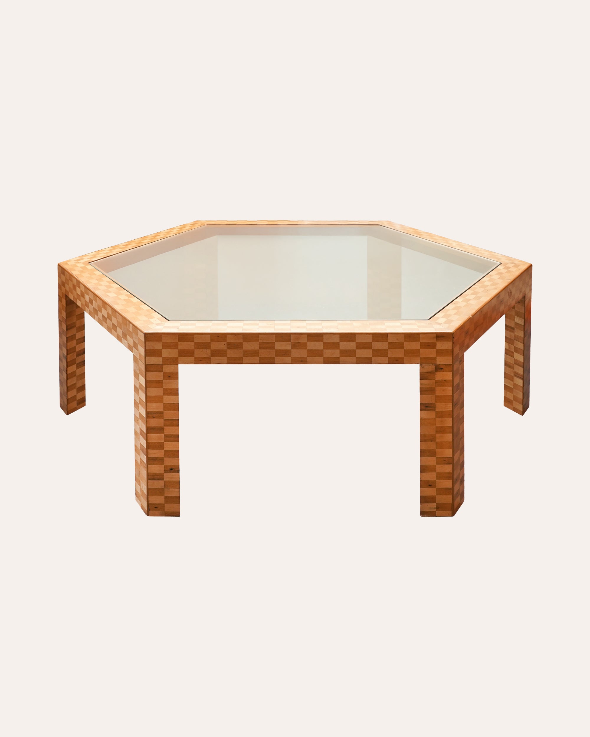 Hexagonal glass table with woven wooden frame on a white background
