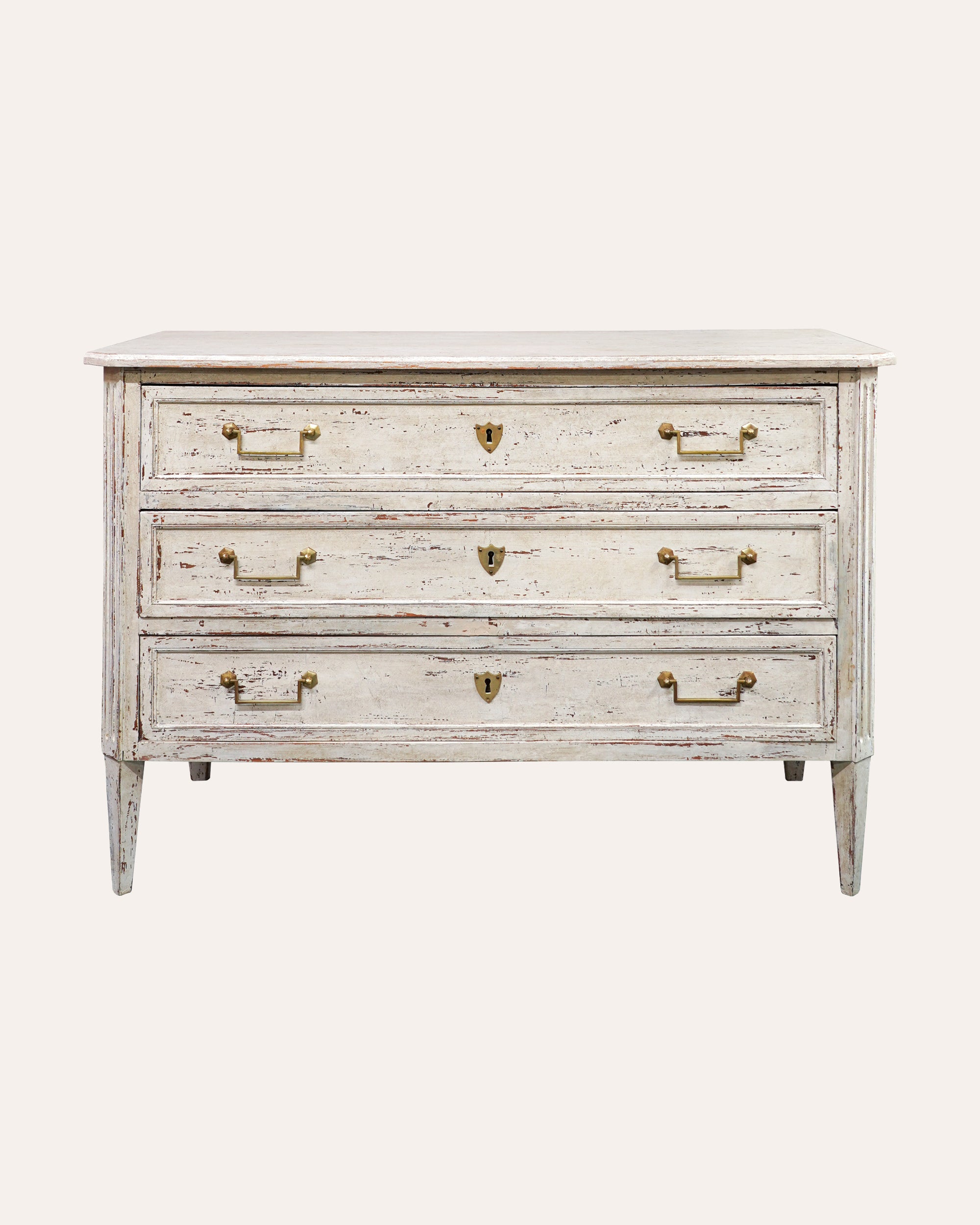 Vintage-style dresser with white distressed finish and brass handles on a white background