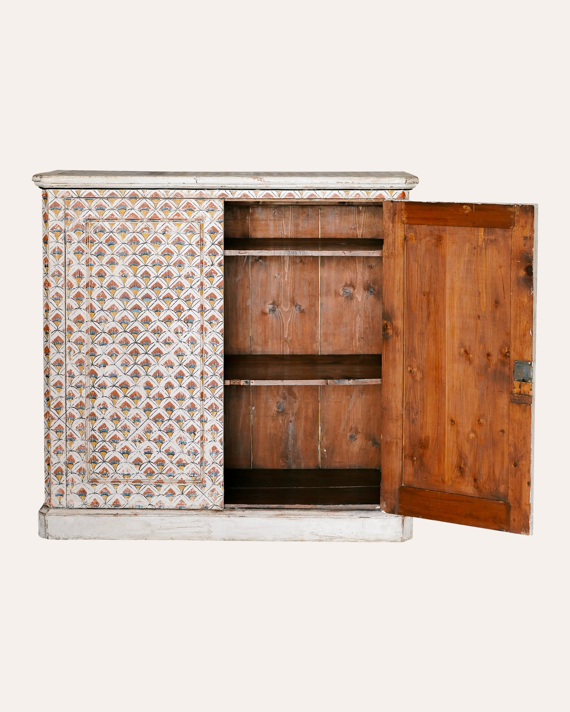 Wooden cabinet with patterned side panel and open door on a white background