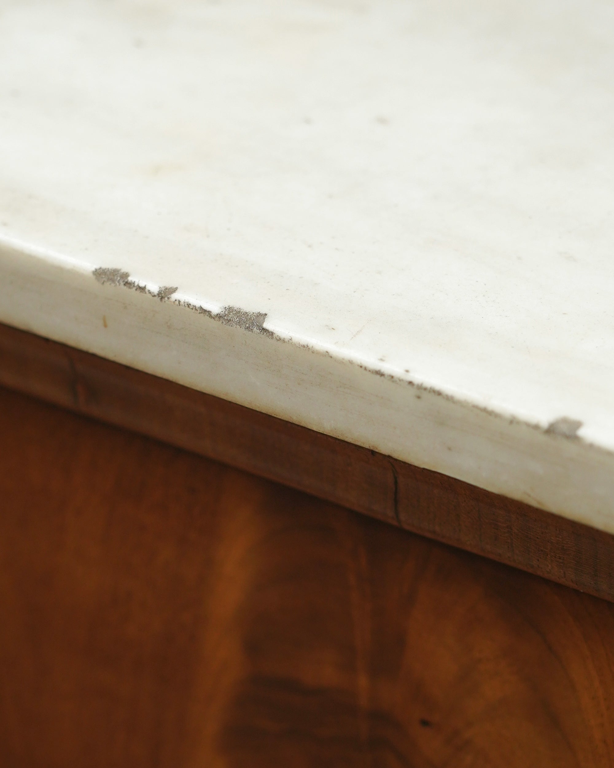 Close up detail image to show the imperfections on the antique side table