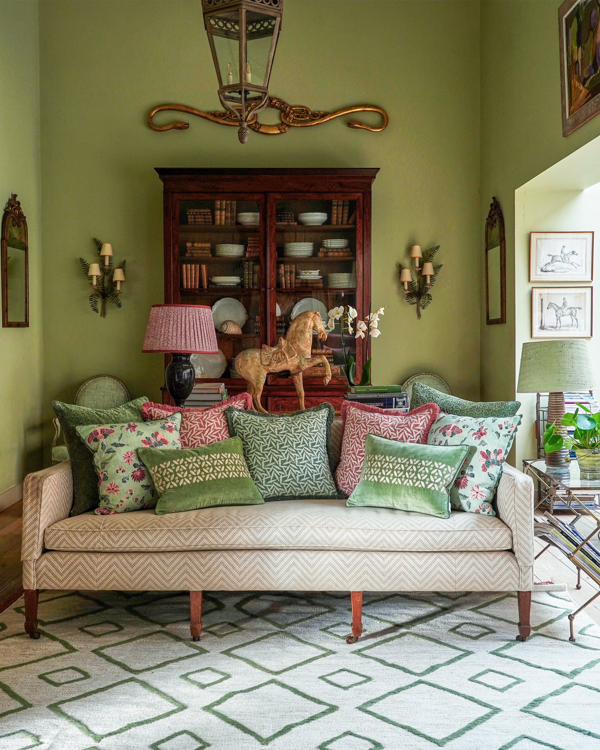 green and pink sitting room with lots of cushions