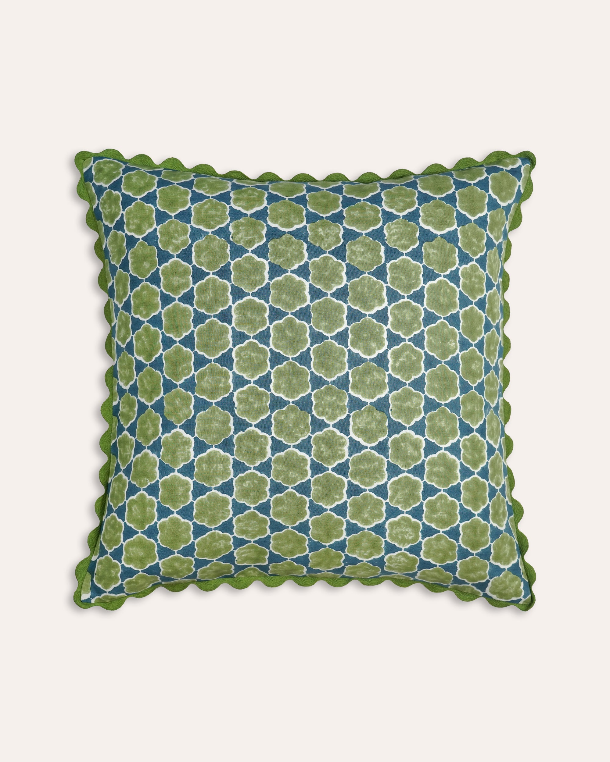Decorative cushion with green geometric pattern on a white background