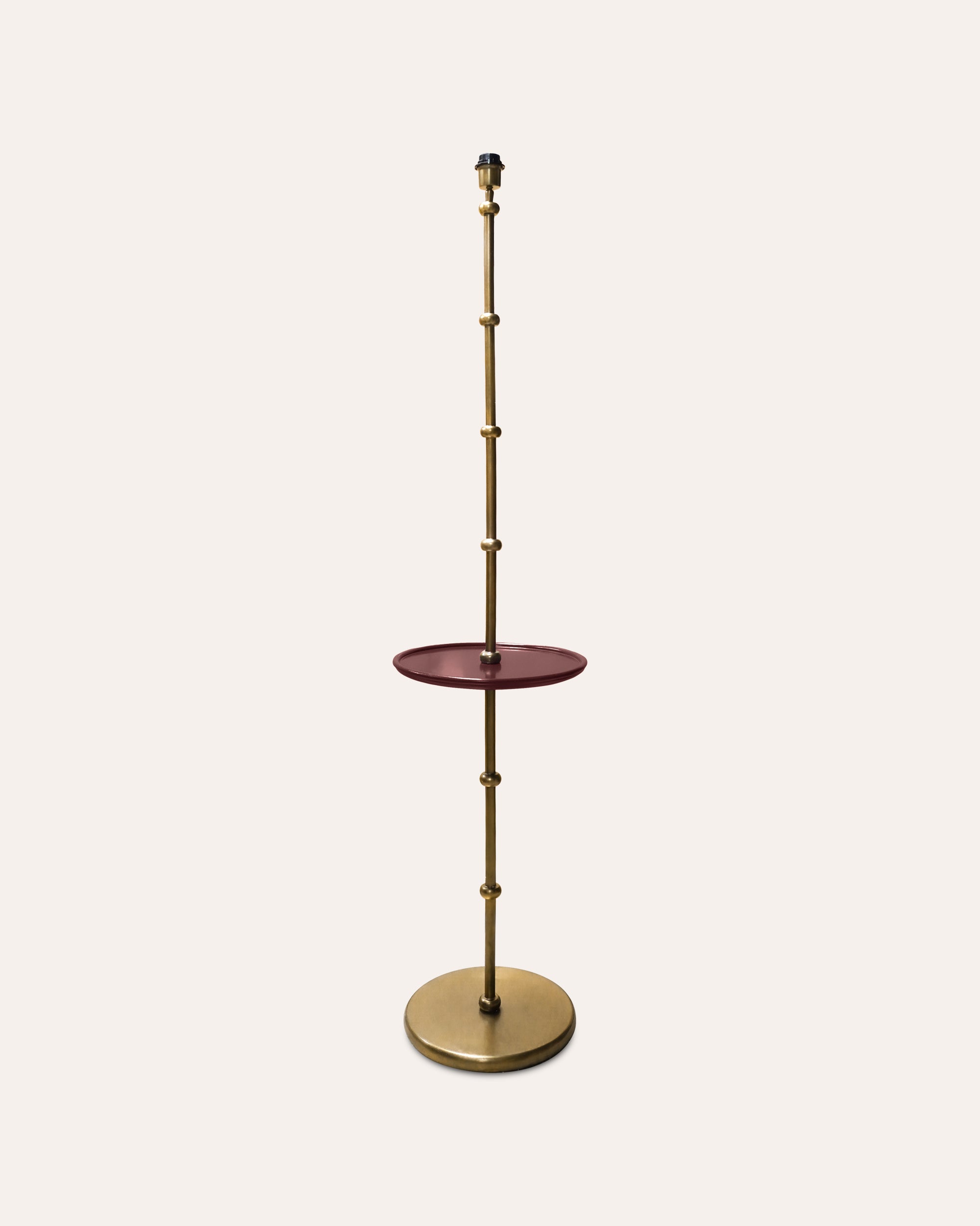 Decorative stand with a round top and brass base on a white background