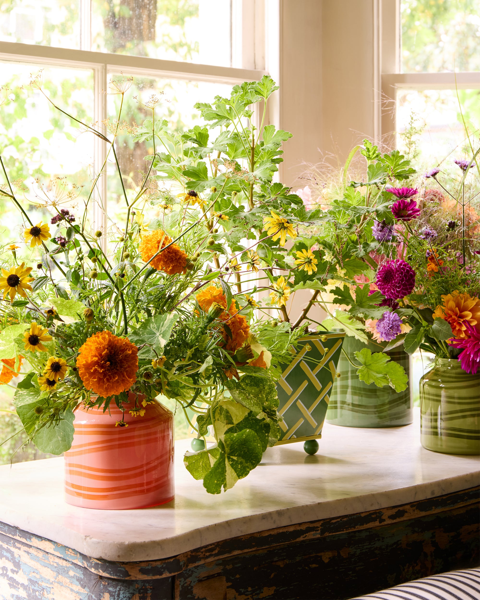 Orange and green vase and planters, styled on an antique table - The Nasturtium collection