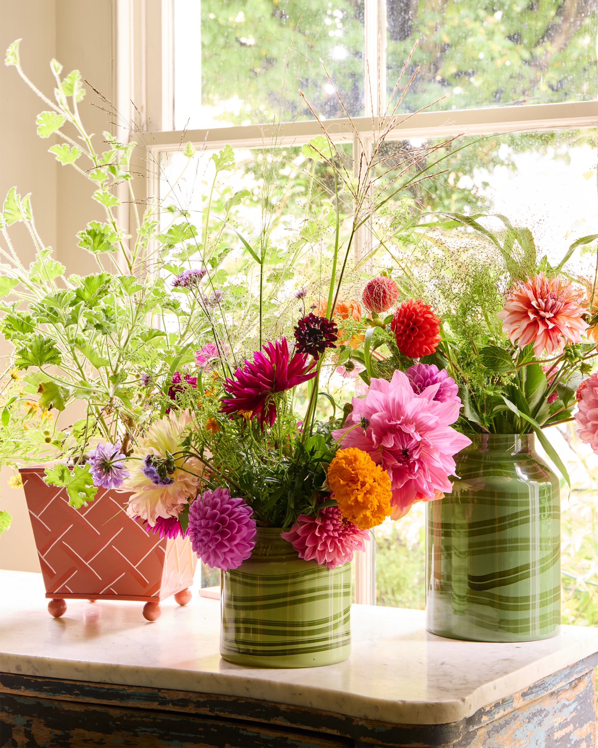 Beautifully styled green Maypole vases styled in a pretty summer flower arrangement