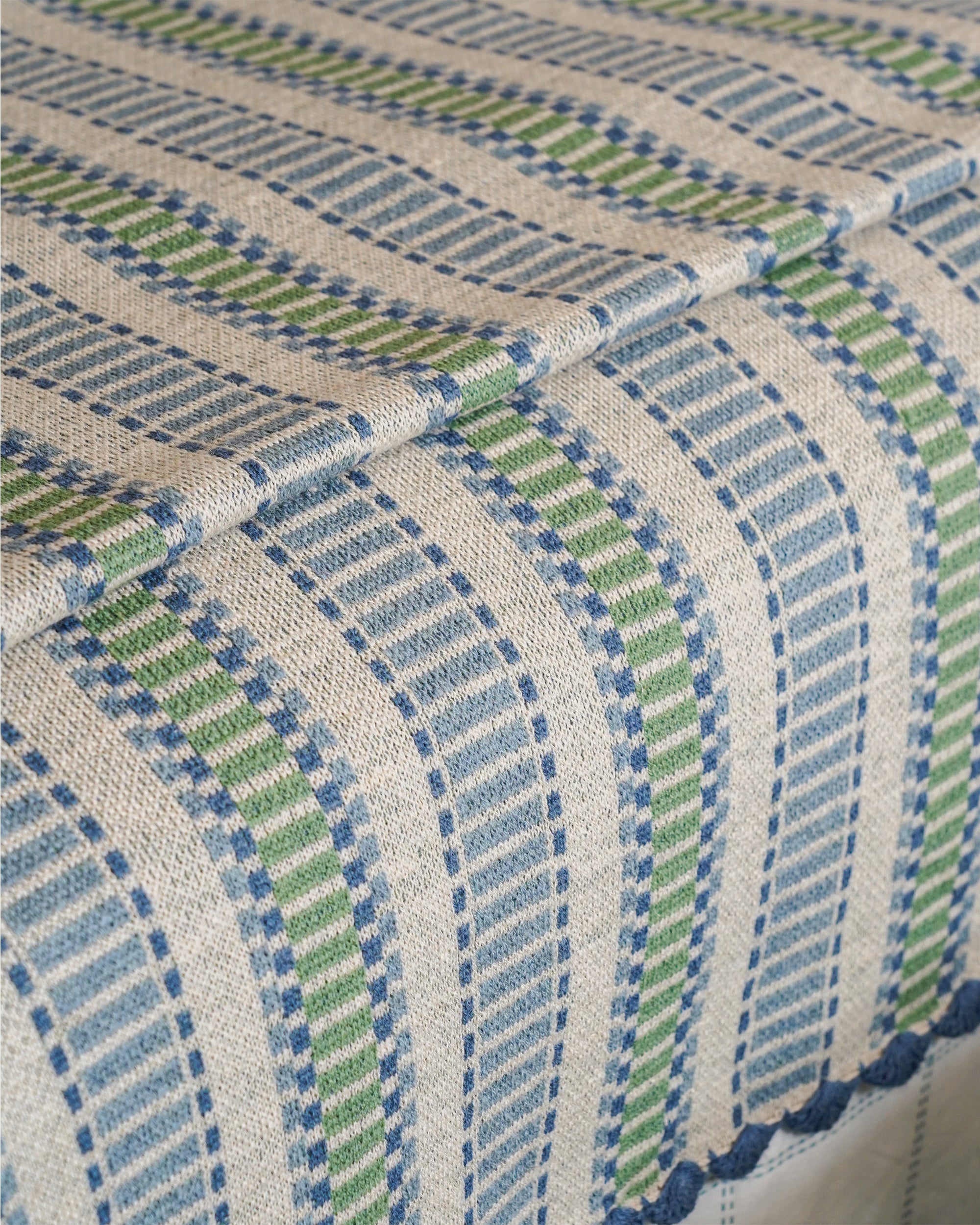 Close-up of a textured striped throw with blue and green pattern