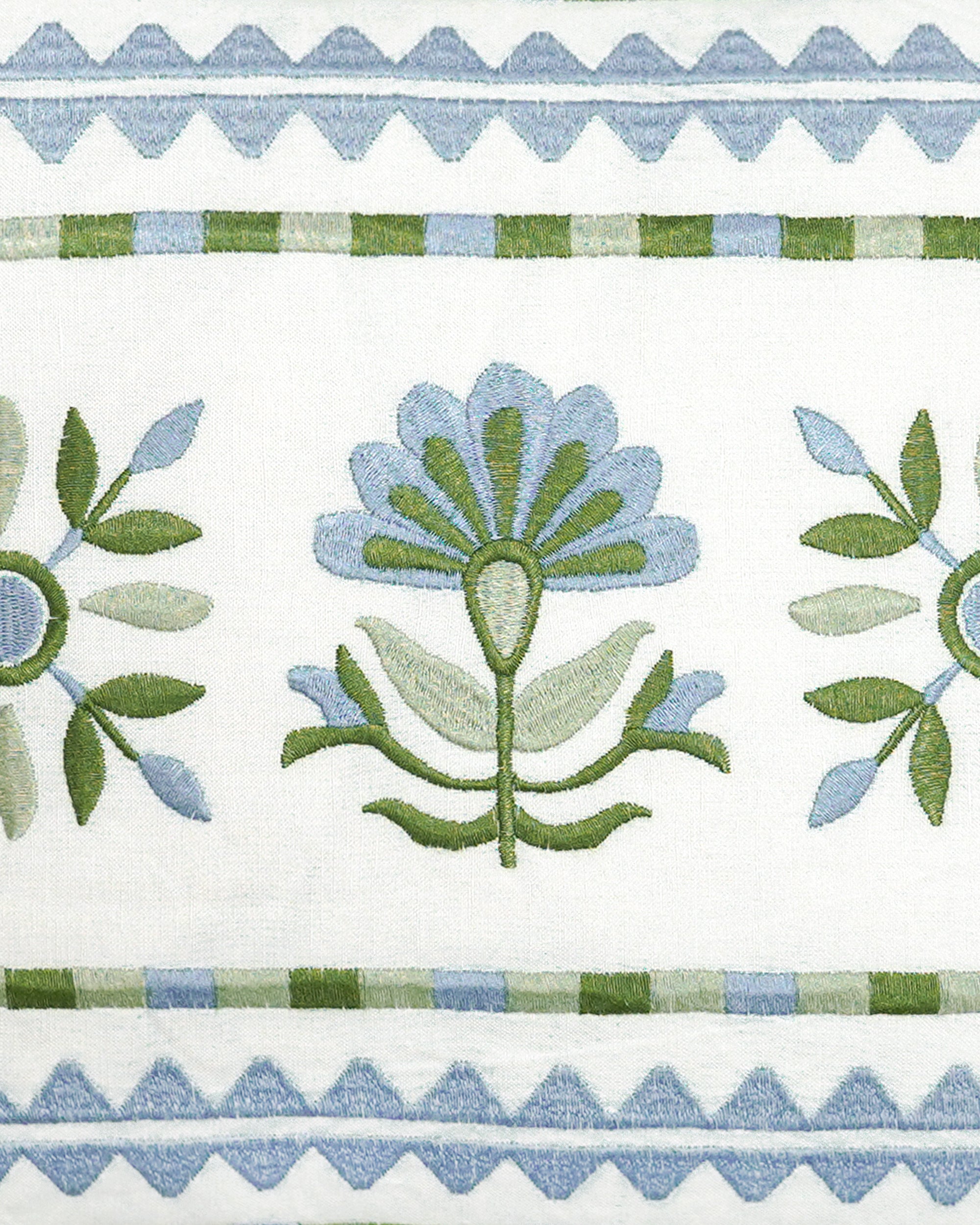 Close up detail image of the blue and green sancti embroidered rectangular spring summer cushion