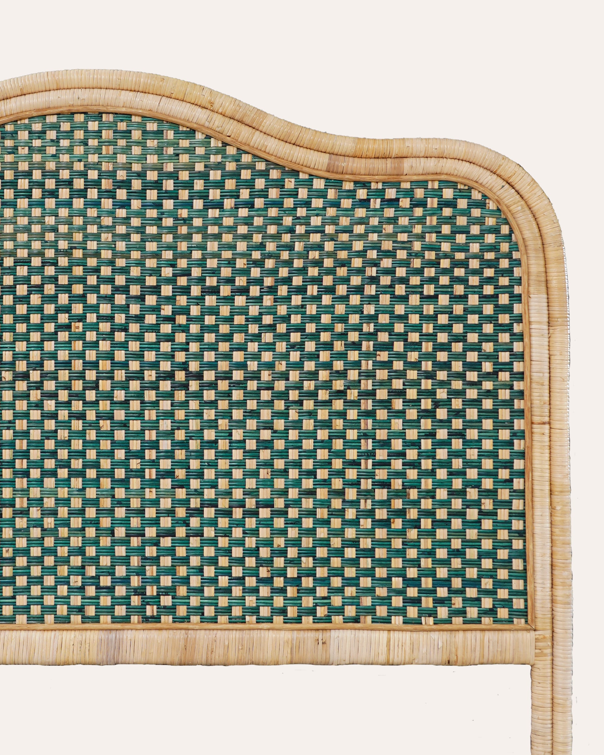 Woven headboard with green and beige pattern on a white background