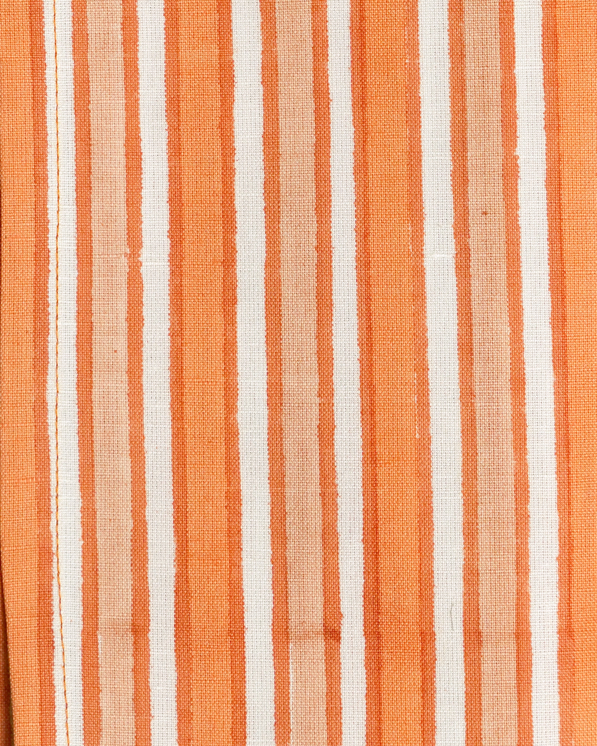 Close up detail image of the orange and pink Sunset Striped napkin