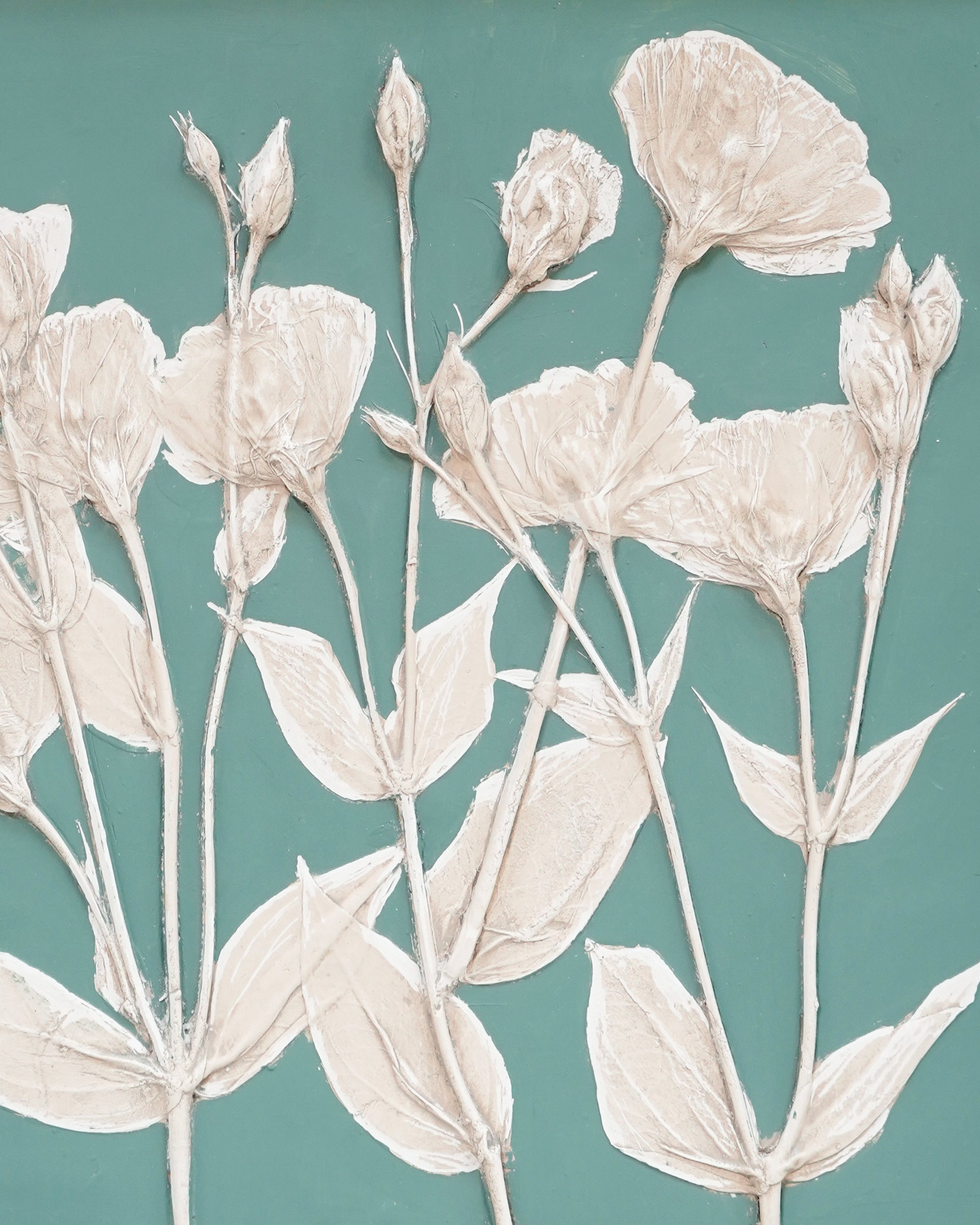 Decorative wall art with beige floral pattern on a teal background