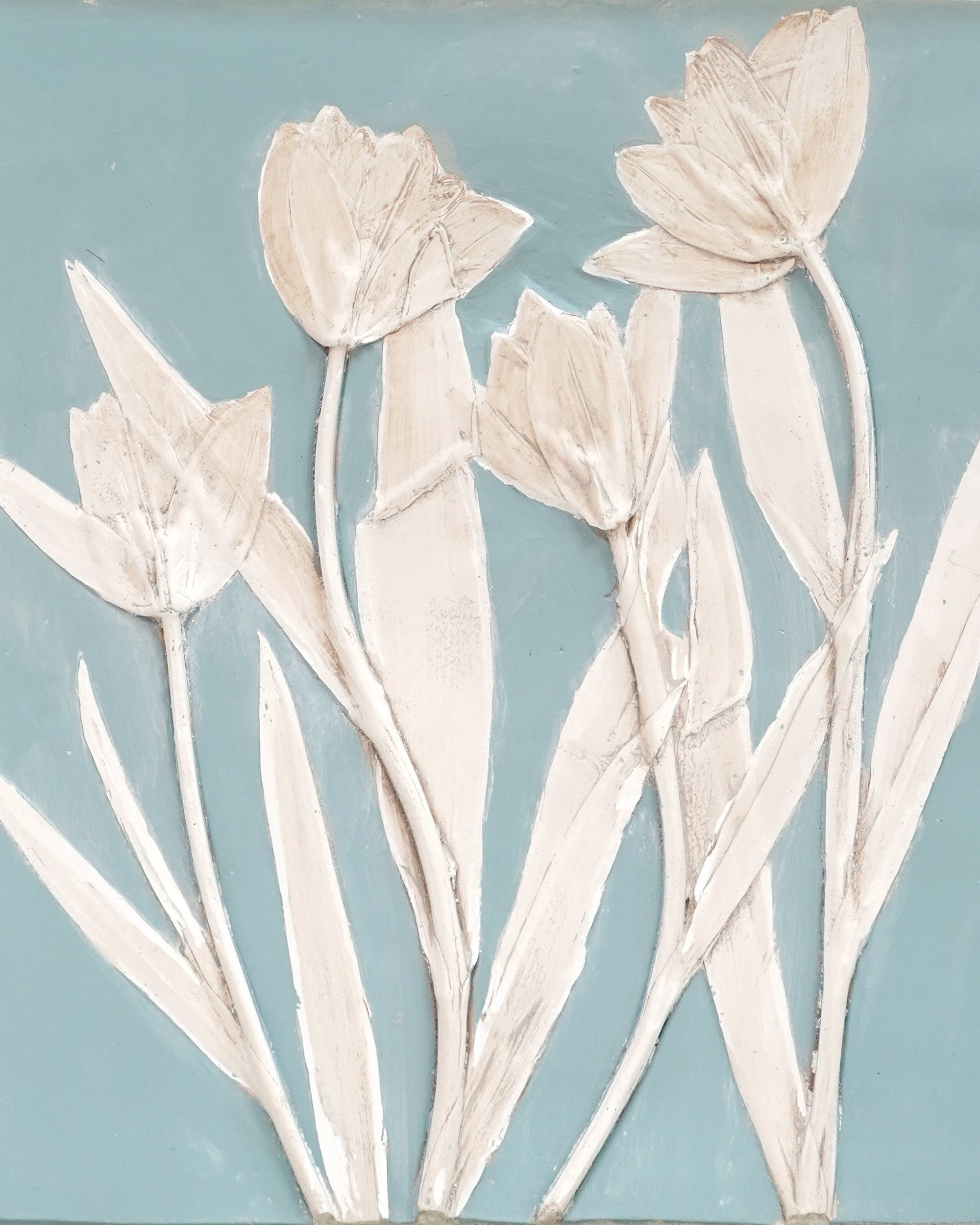 Decorative wall art with white tulips on a light blue background