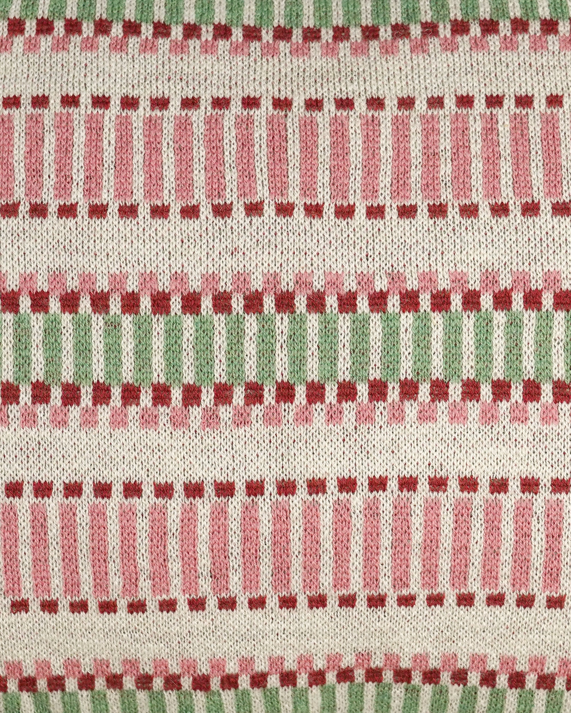 Close up detail of the red and green knitted striped rectangular cuhion
