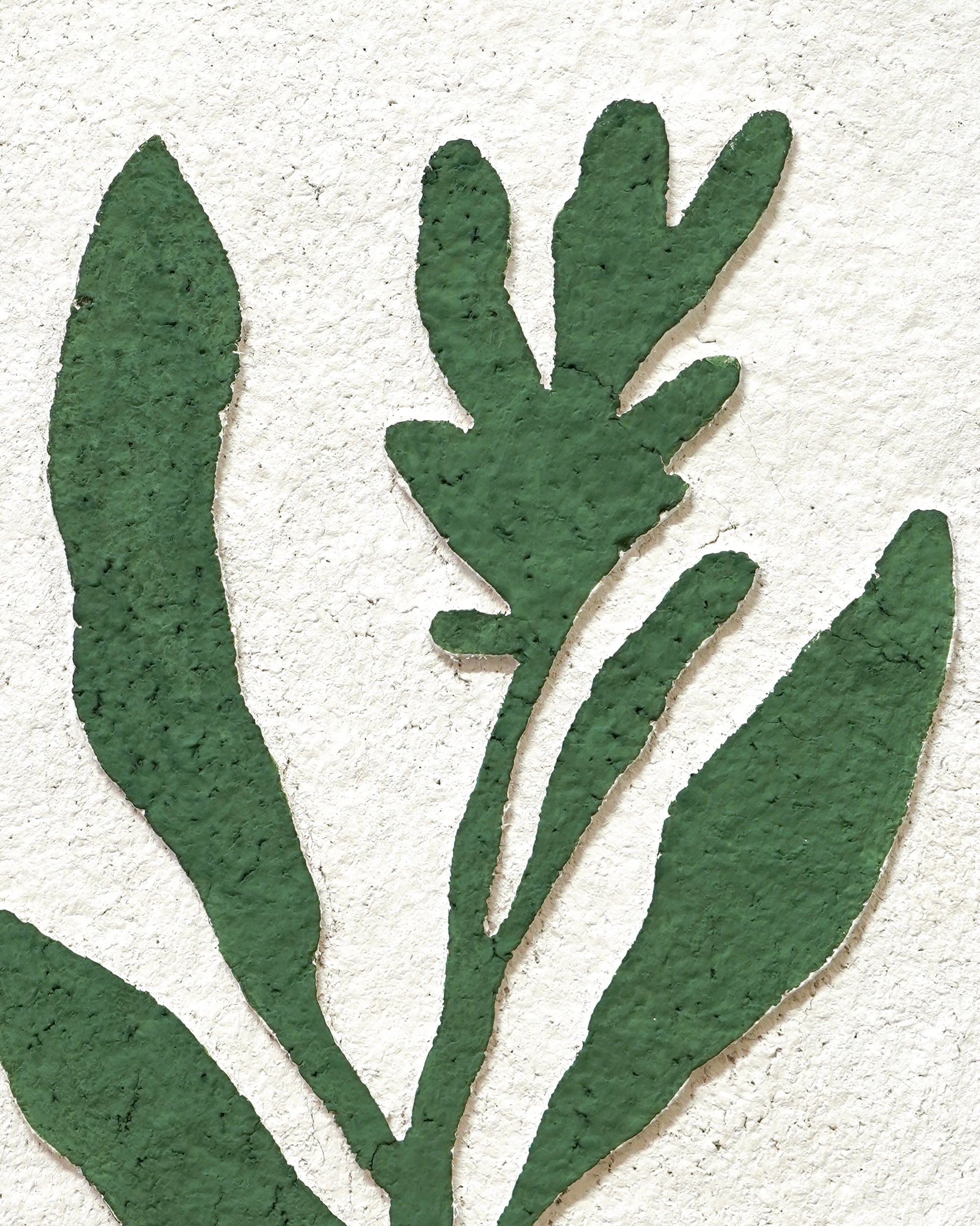 Green leafy pattern on a textured white background