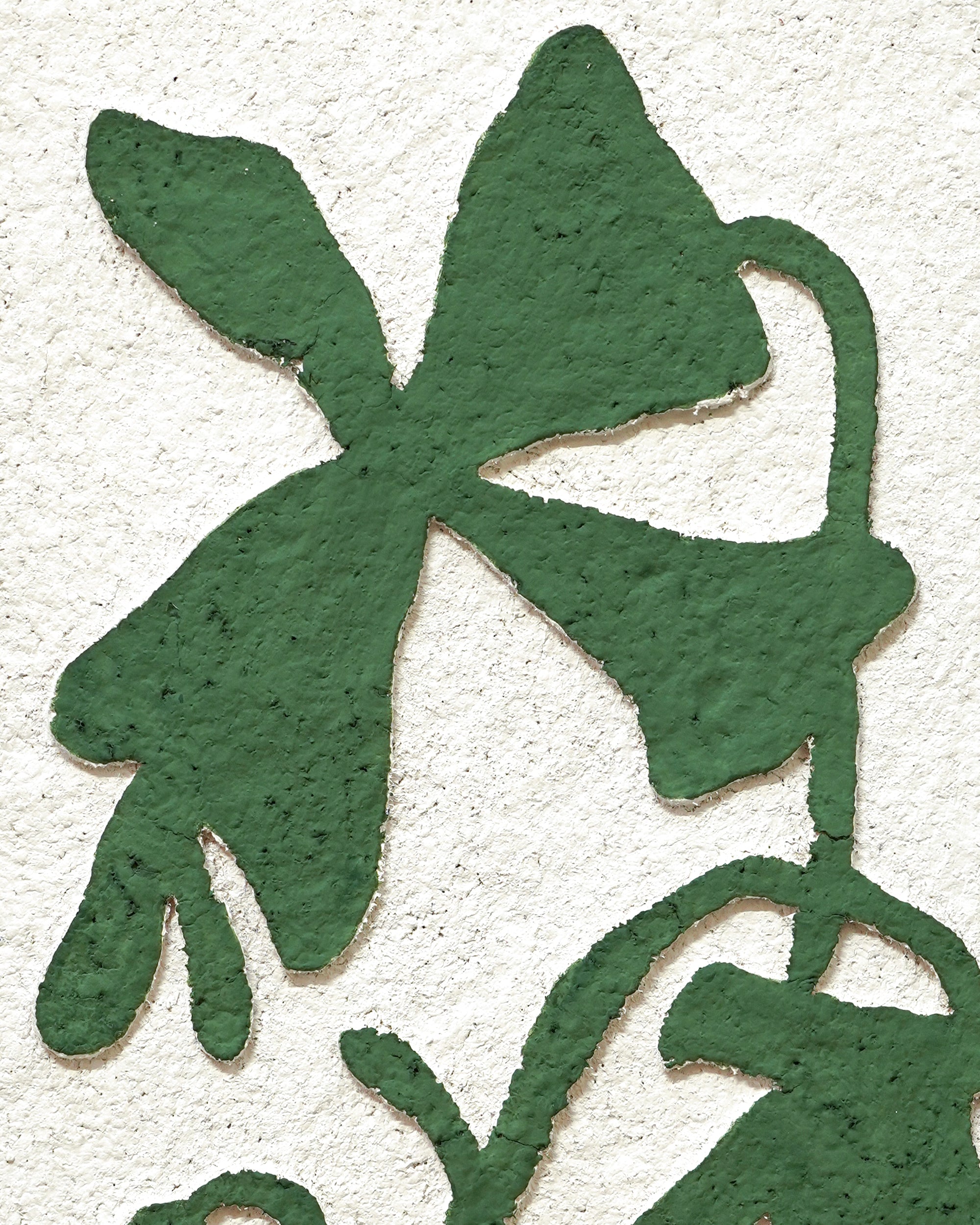 Green floral artwork on a textured white background