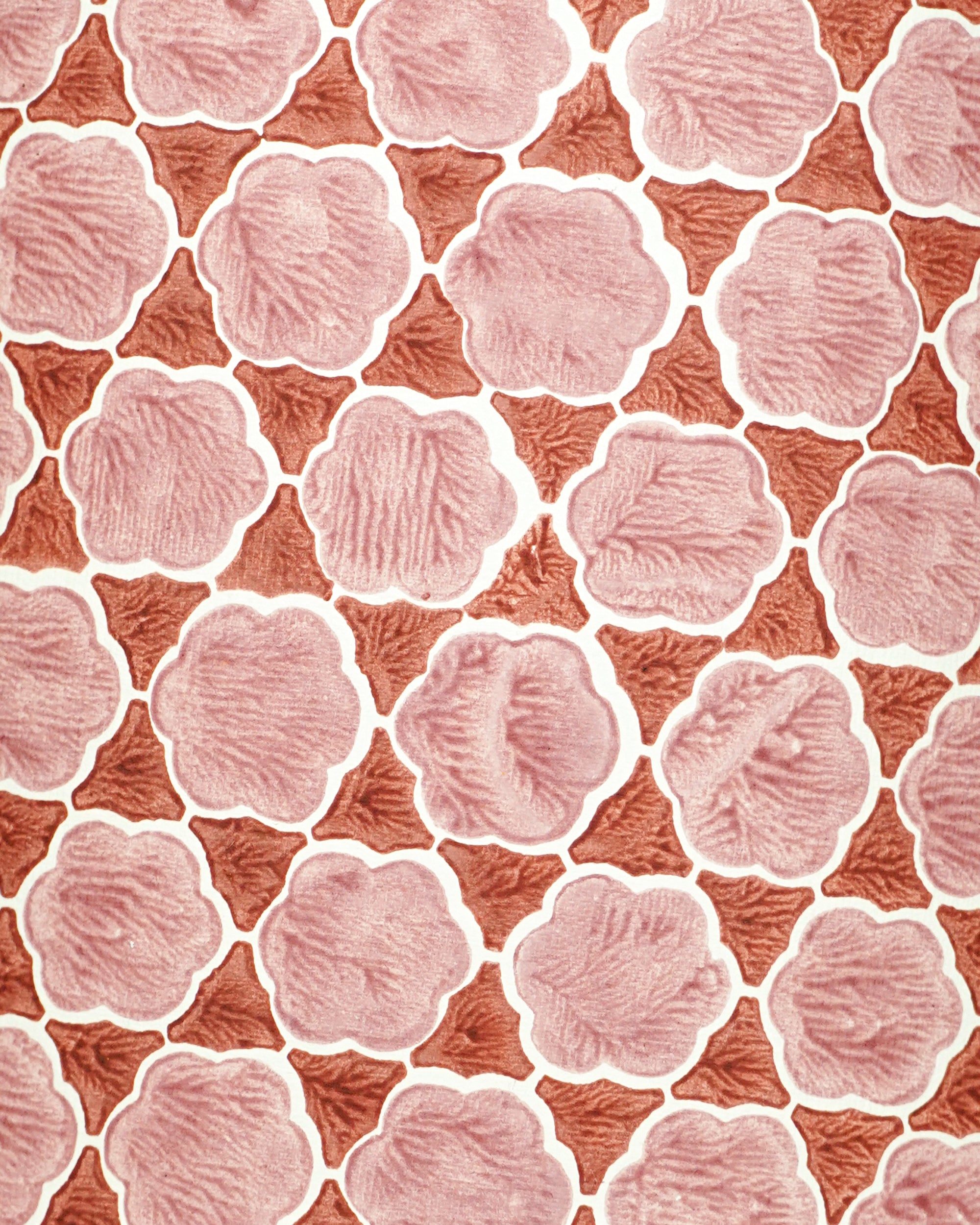 Lampshade with a pattern of pink flower-like shapes on a red background