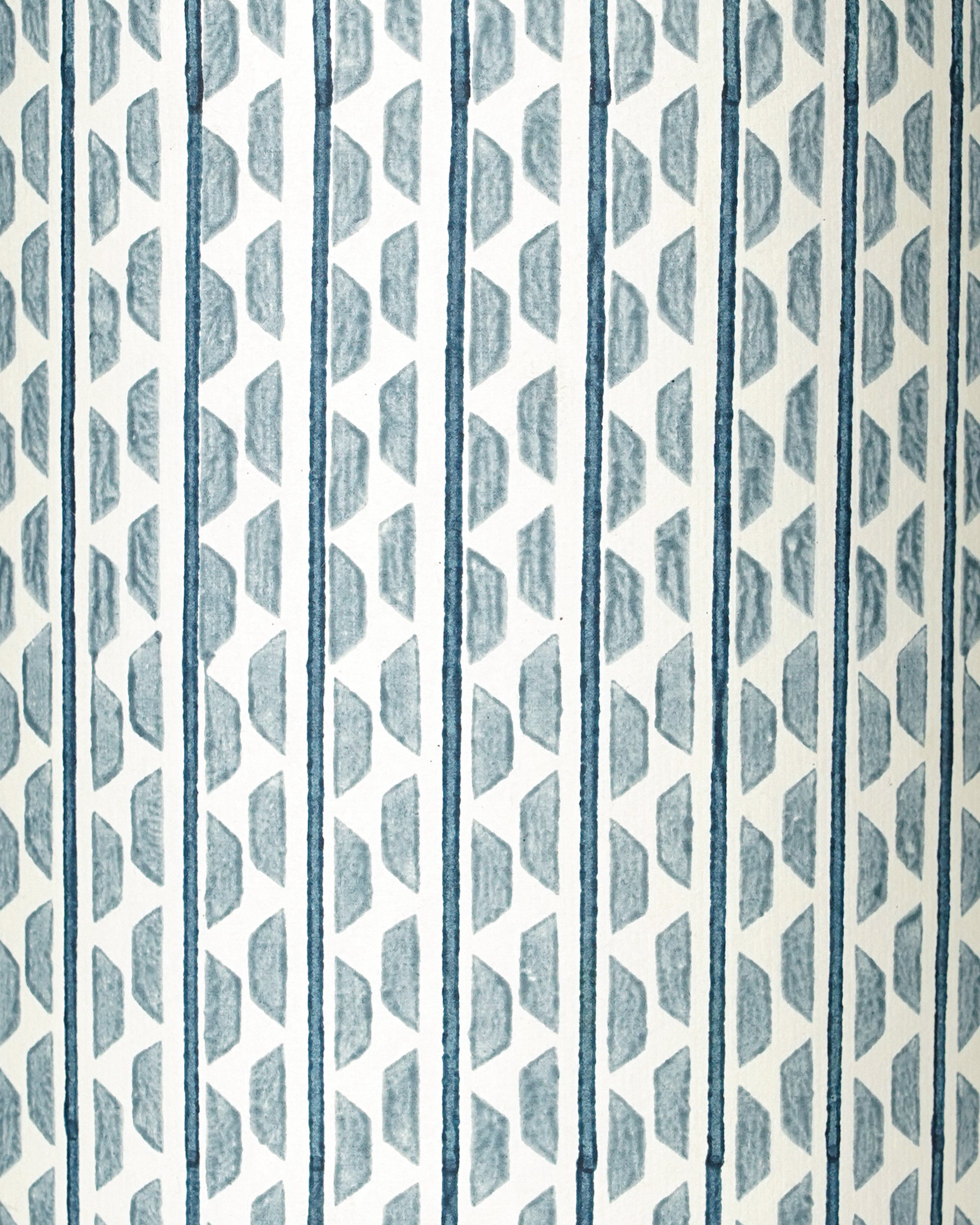 Patterned wall light shade close up. with blue and white geometric design