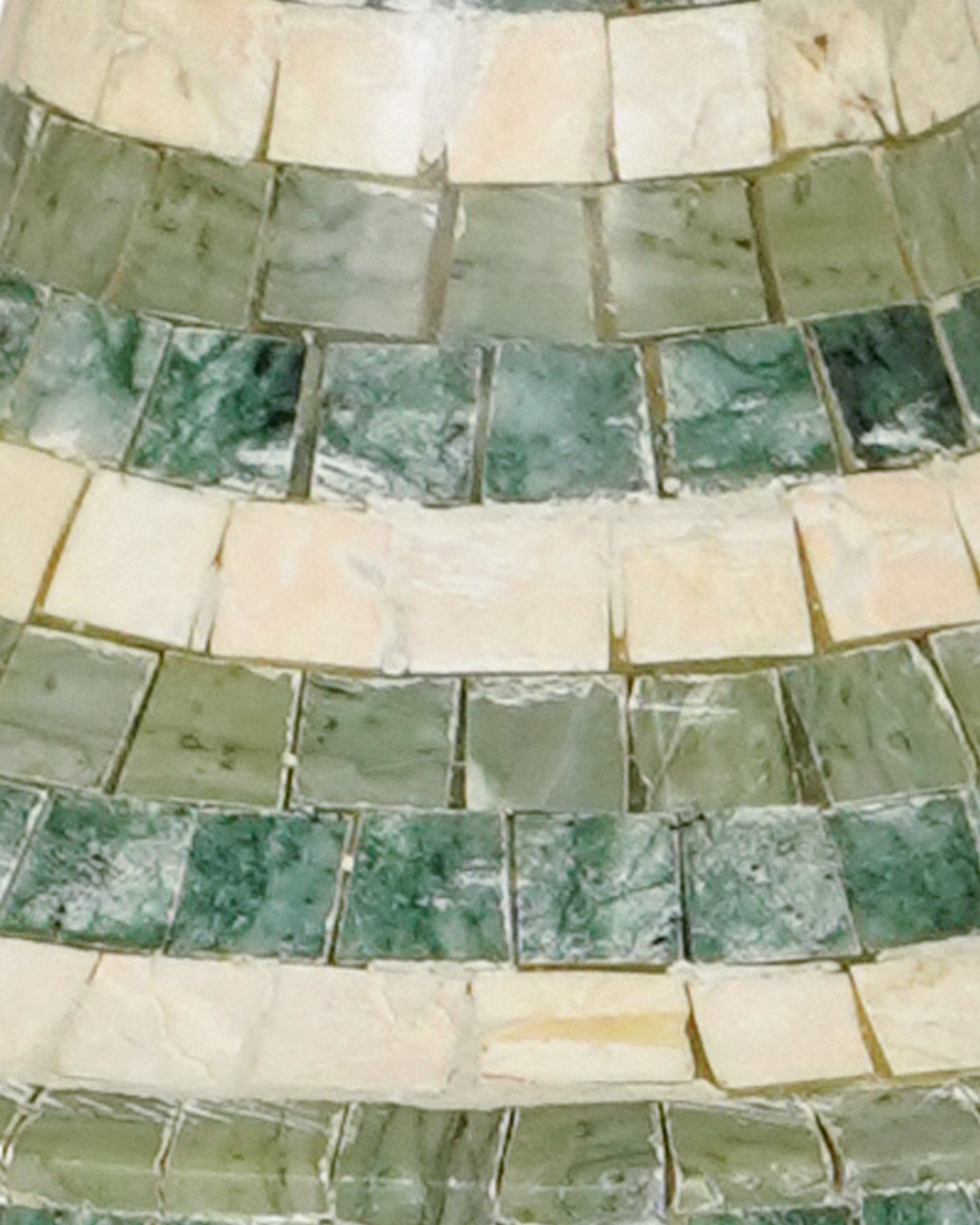 Close-up of a mosaic pattern with green and beige tiles