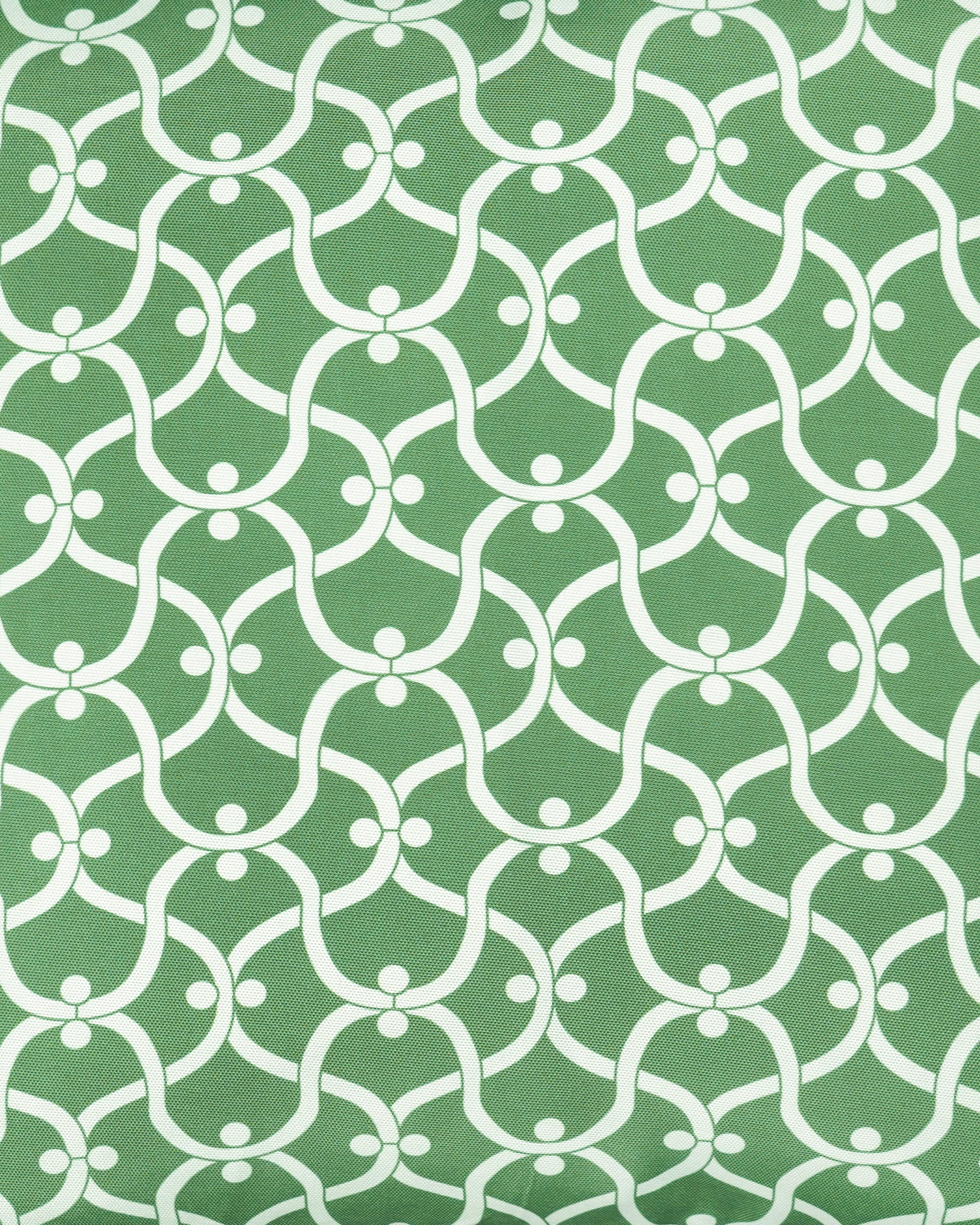 Close up detail of the Ogee green outdoor cushion with a white geometric pattern