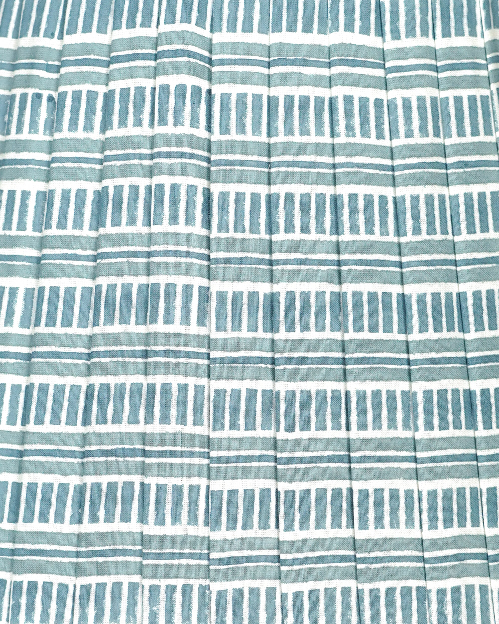 Close up detail of a blue and white striped pleated lampshade